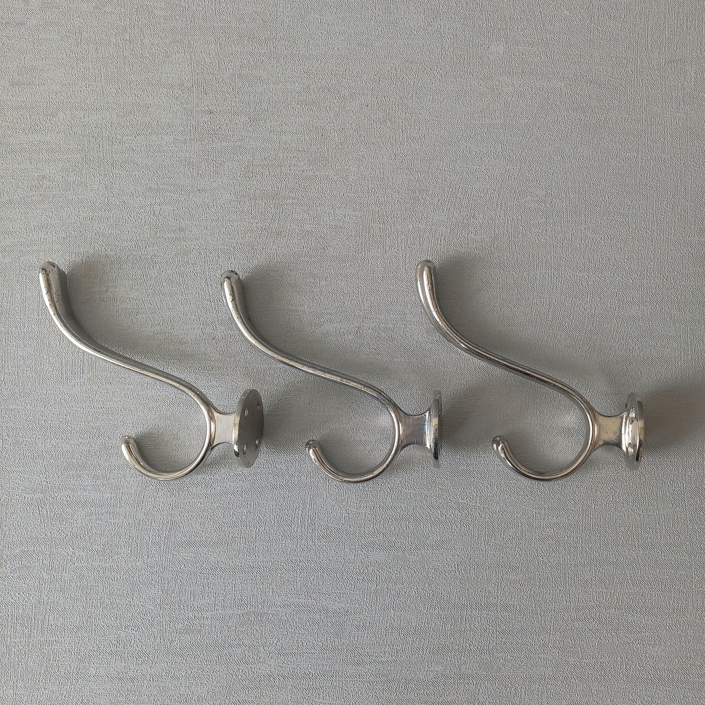 3 x French vintage silver coloured metal coat hooks in used sturdy used condition. Good for coat storage, dog leads, or maybe in the kitchen or bathroom for towels.
Circa. 1930s/1950s.