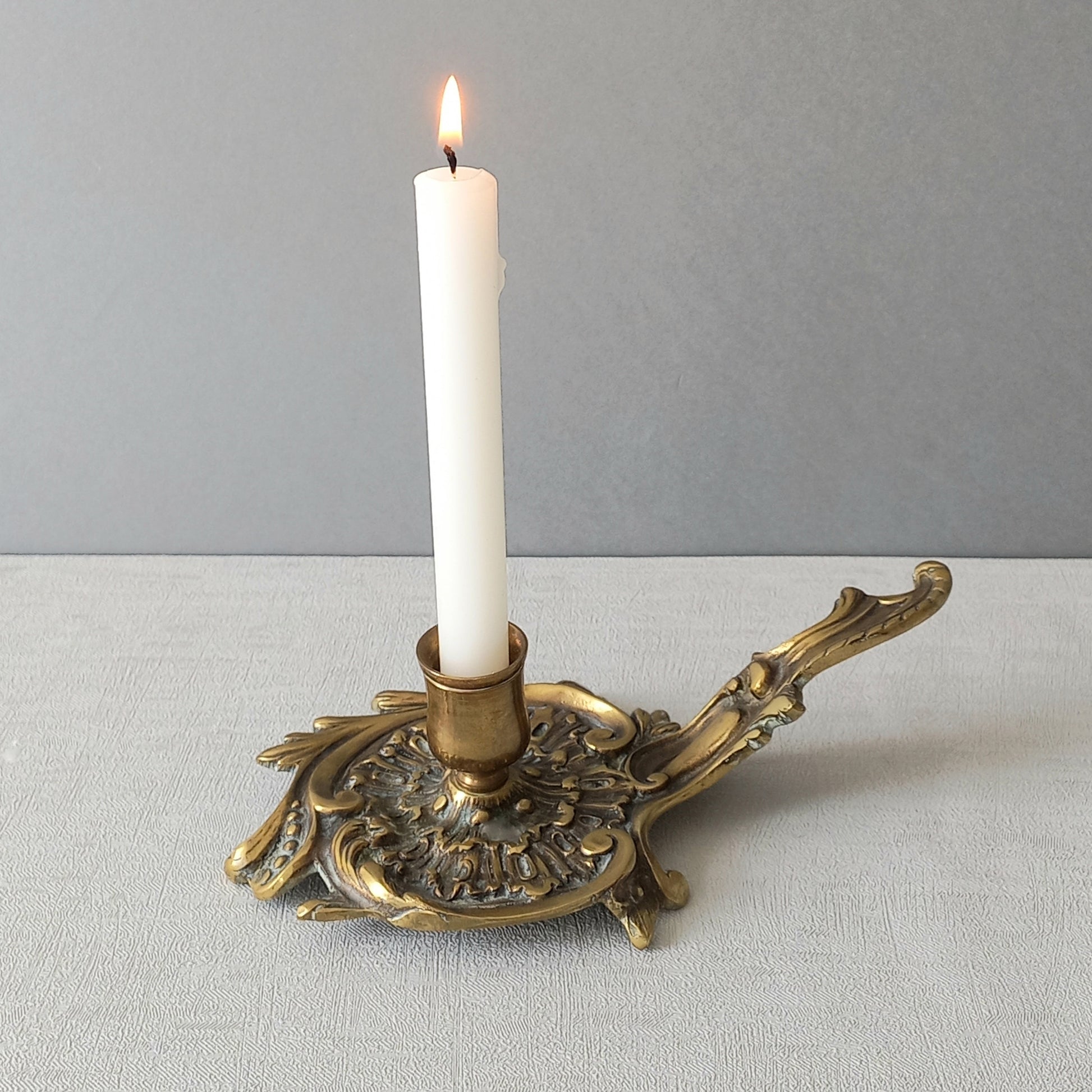 An original French antique brass/bronze chamber stick, a small, heavy for its size and decorative antique candle holder that will be a welcome addition to any interior.