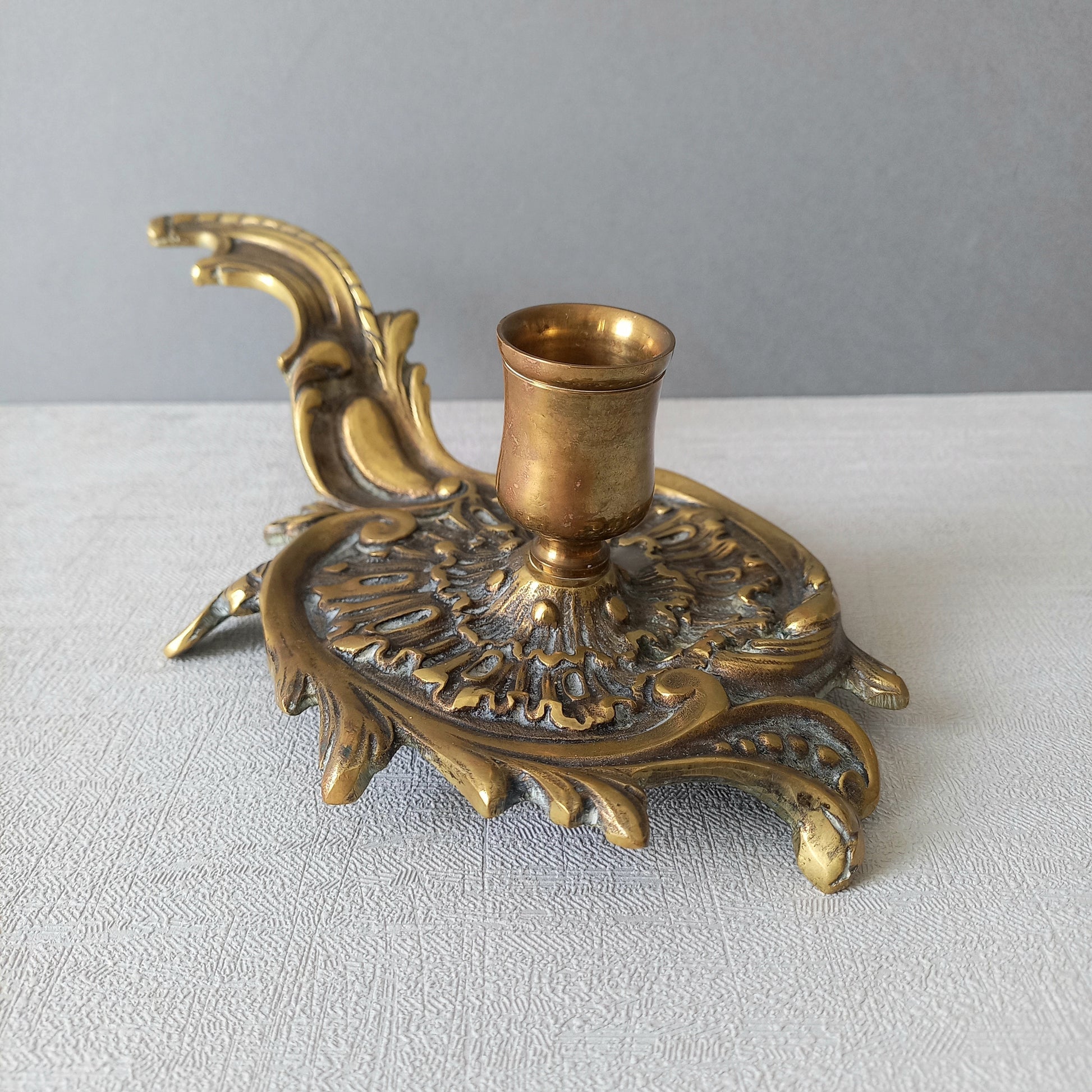 An original French antique brass/bronze chamber stick, a small, heavy for its size and decorative antique candle holder that will be a welcome addition to any interior.