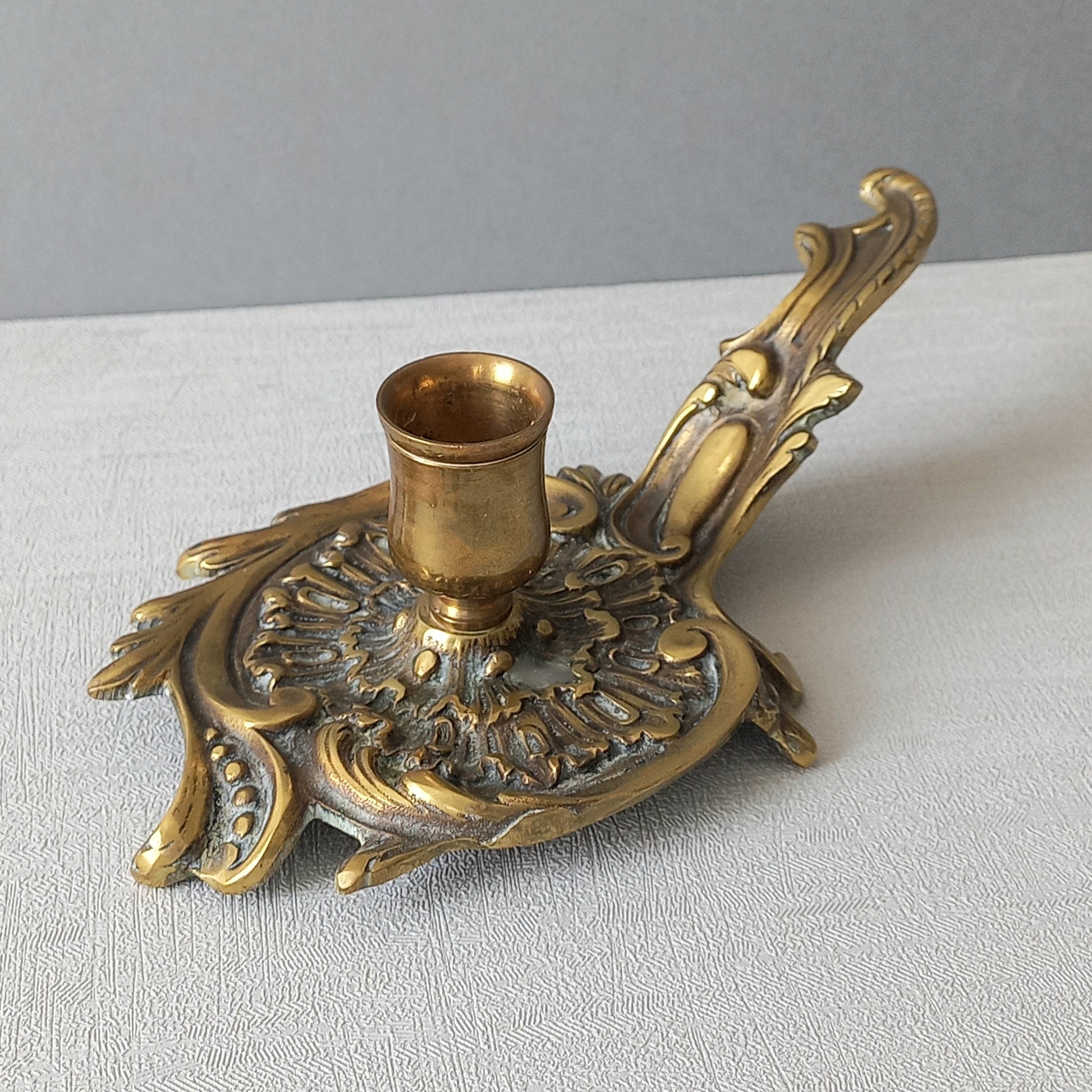 An original French antique brass/bronze chamber stick, a small, heavy for its size and decorative antique candle holder that will be a welcome addition to any interior.