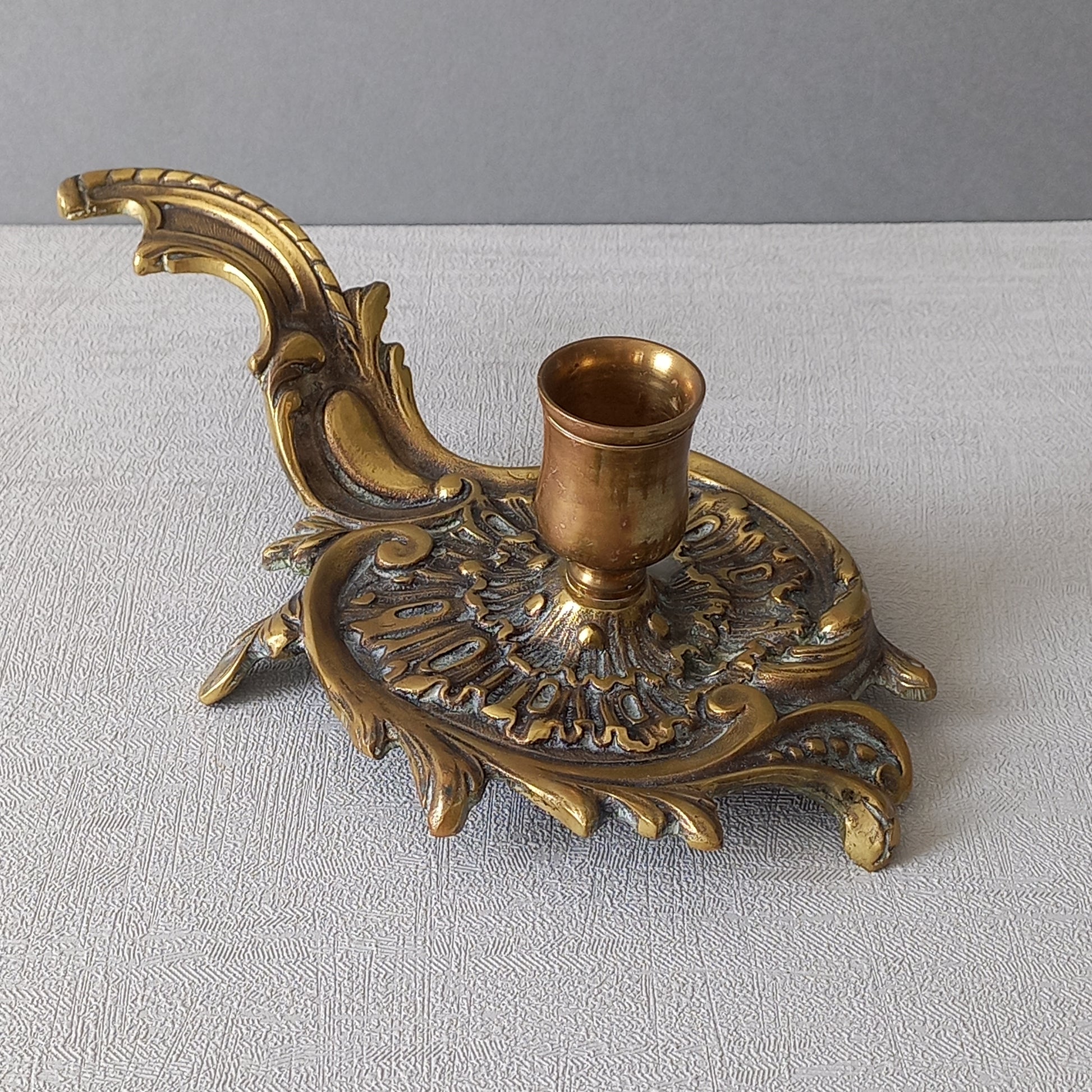 An original French antique brass/bronze chamber stick, a small, heavy for its size and decorative antique candle holder that will be a welcome addition to any interior.
