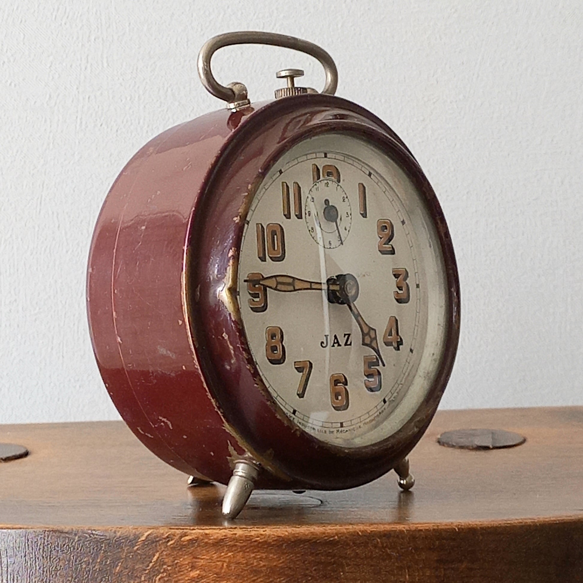 A handsome little vintage alarm clock by premier French manufacturer, Jaz.
This wonderful little clock is in semi-working condition including the alarm, although I should note that being an old time piece dating from the pre-1940 period he's temperamental and sometimes will just stop working, although all that's needed is a gentle shake from side to side and he will once more begin to tick - sometimes you might have to repeat this and have patience with him.