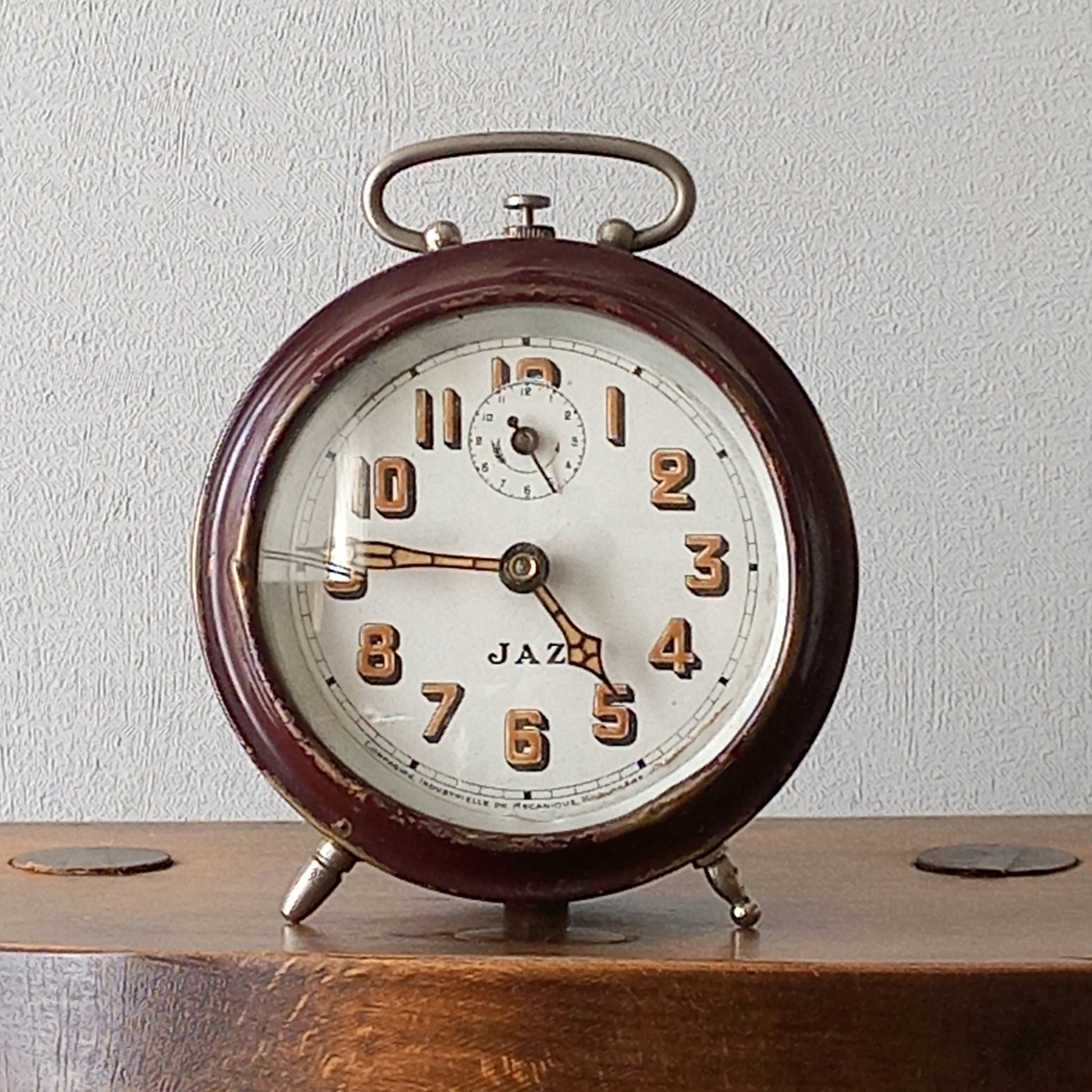 A handsome little vintage alarm clock by premier French manufacturer, Jaz.
This wonderful little clock is in semi-working condition including the alarm, although I should note that being an old time piece dating from the pre-1940 period he's temperamental and sometimes will just stop working, although all that's needed is a gentle shake from side to side and he will once more begin to tick - sometimes you might have to repeat this and have patience with him.