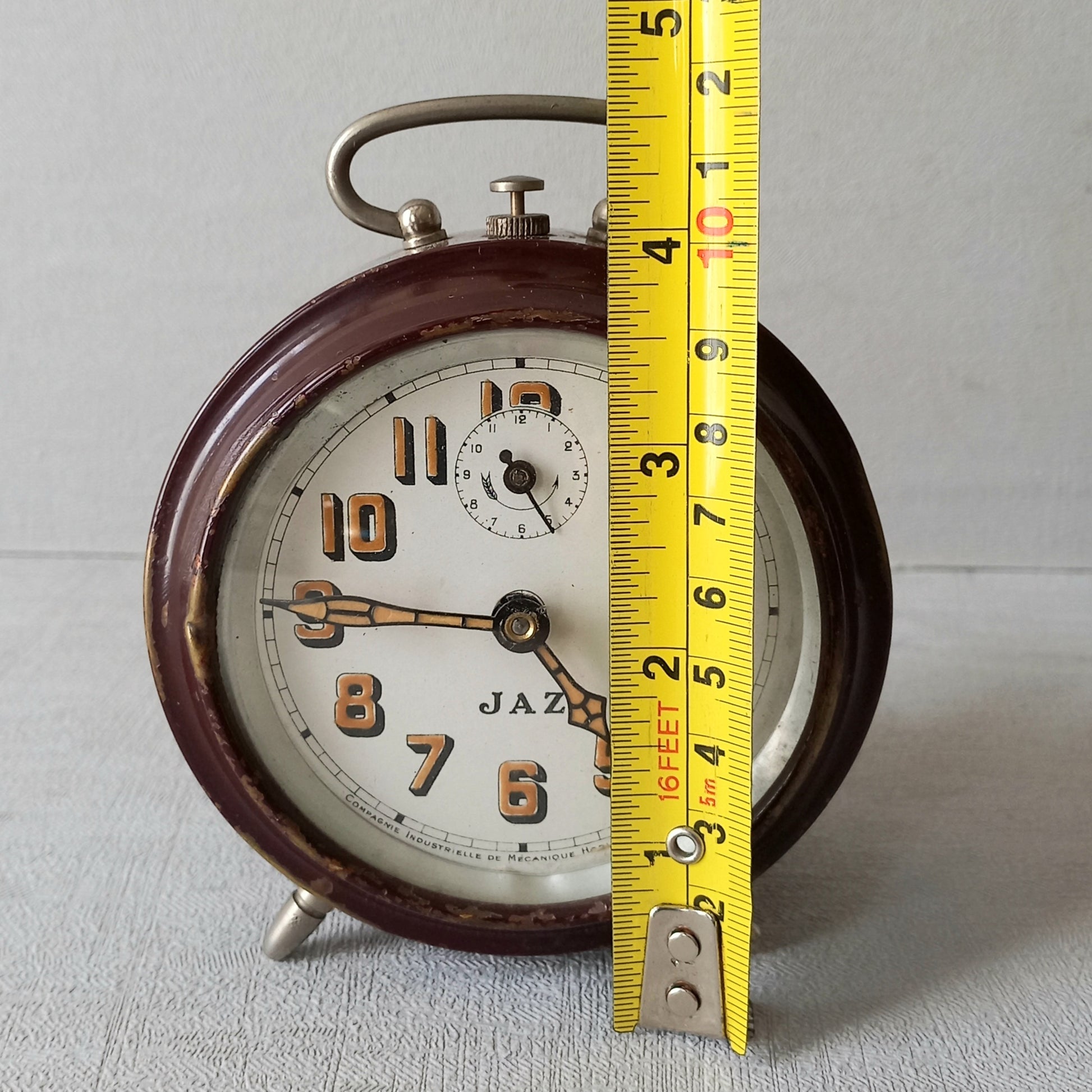 A handsome little vintage alarm clock by premier French manufacturer, Jaz.
This wonderful little clock is in semi-working condition including the alarm, although I should note that being an old time piece dating from the pre-1940 period he's temperamental and sometimes will just stop working, although all that's needed is a gentle shake from side to side and he will once more begin to tick - sometimes you might have to repeat this and have patience with him.