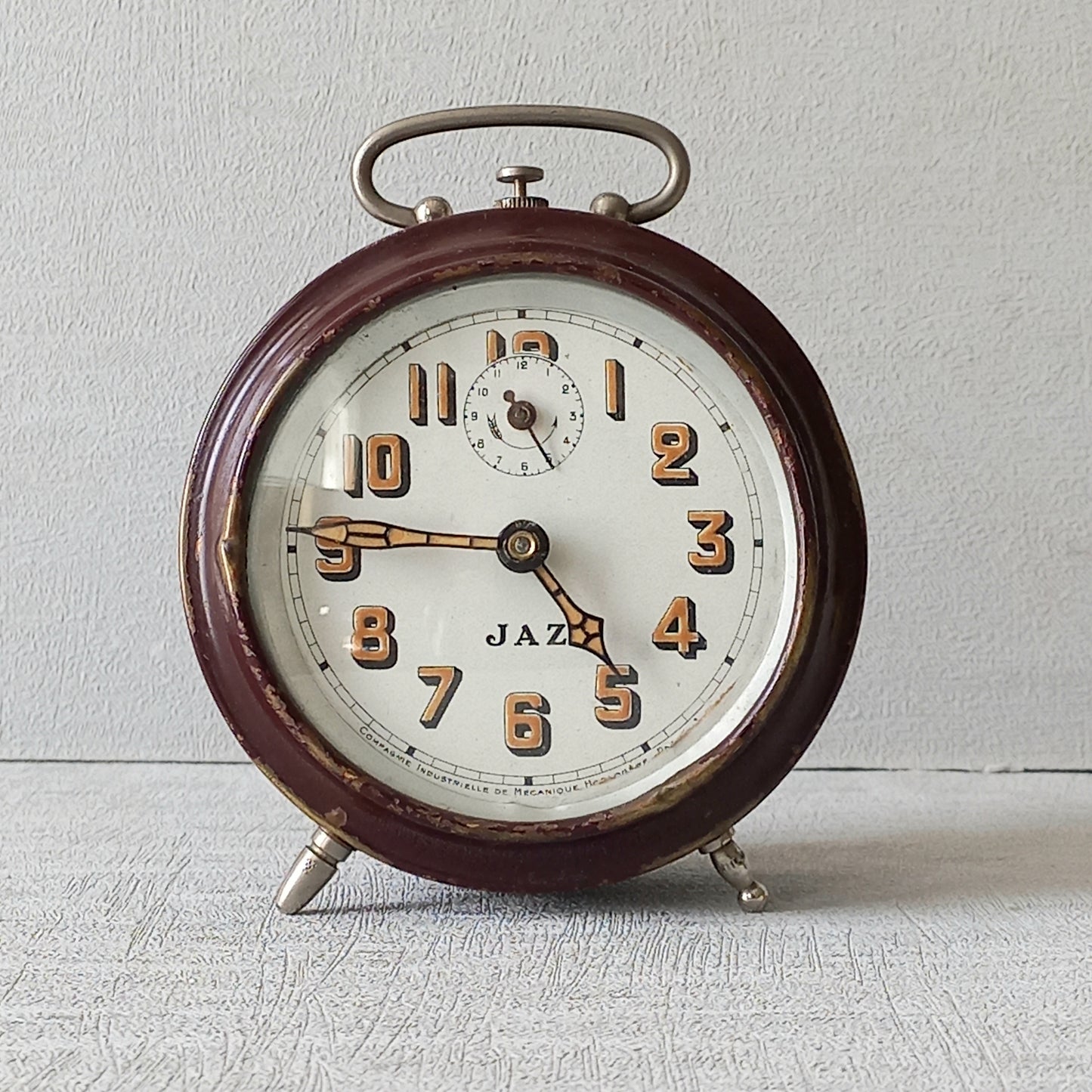 A handsome little vintage alarm clock by premier French manufacturer, Jaz.
This wonderful little clock is in semi-working condition including the alarm, although I should note that being an old time piece dating from the pre-1940 period he's temperamental and sometimes will just stop working, although all that's needed is a gentle shake from side to side and he will once more begin to tick - sometimes you might have to repeat this and have patience with him.