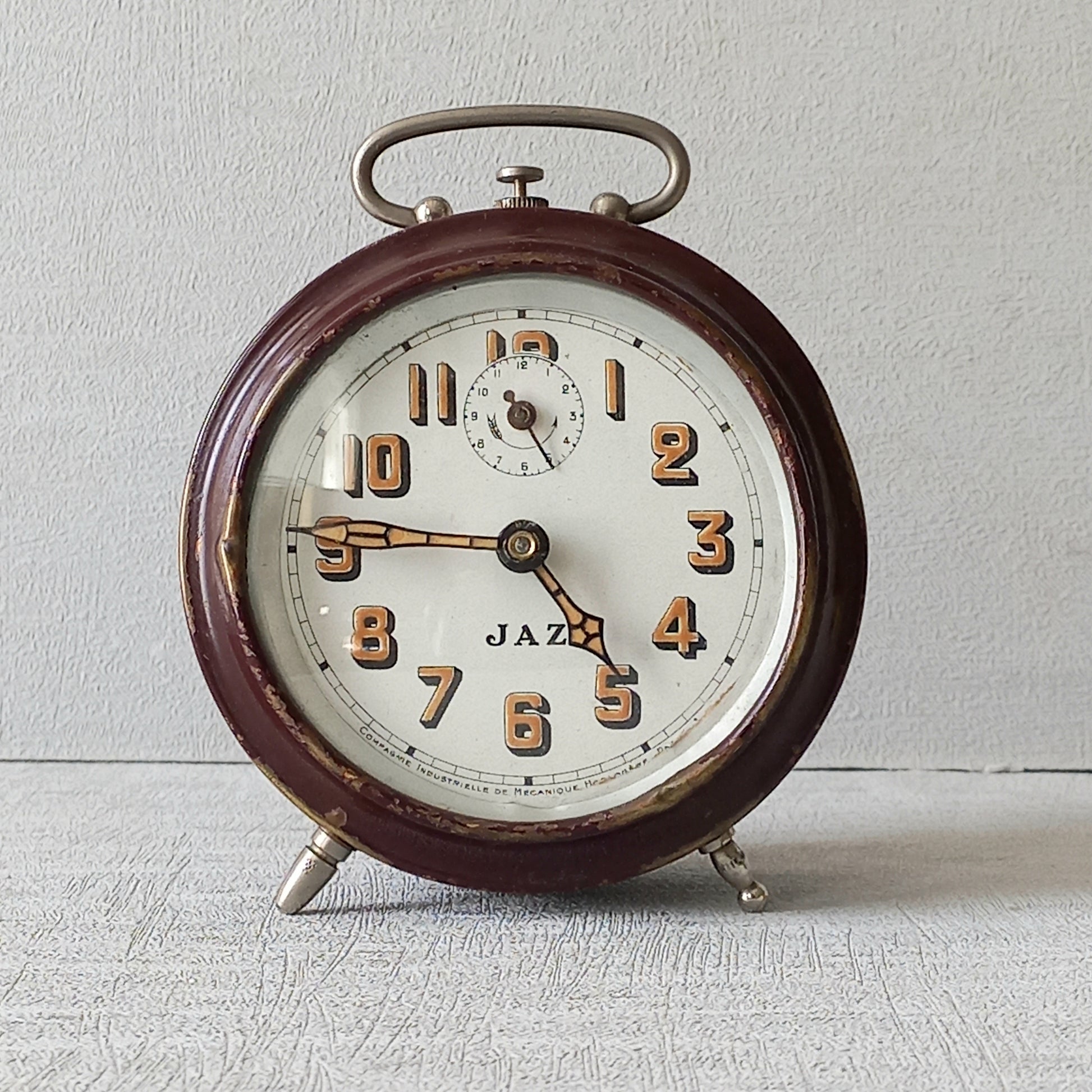 A handsome little vintage alarm clock by premier French manufacturer, Jaz.
This wonderful little clock is in semi-working condition including the alarm, although I should note that being an old time piece dating from the pre-1940 period he's temperamental and sometimes will just stop working, although all that's needed is a gentle shake from side to side and he will once more begin to tick - sometimes you might have to repeat this and have patience with him.