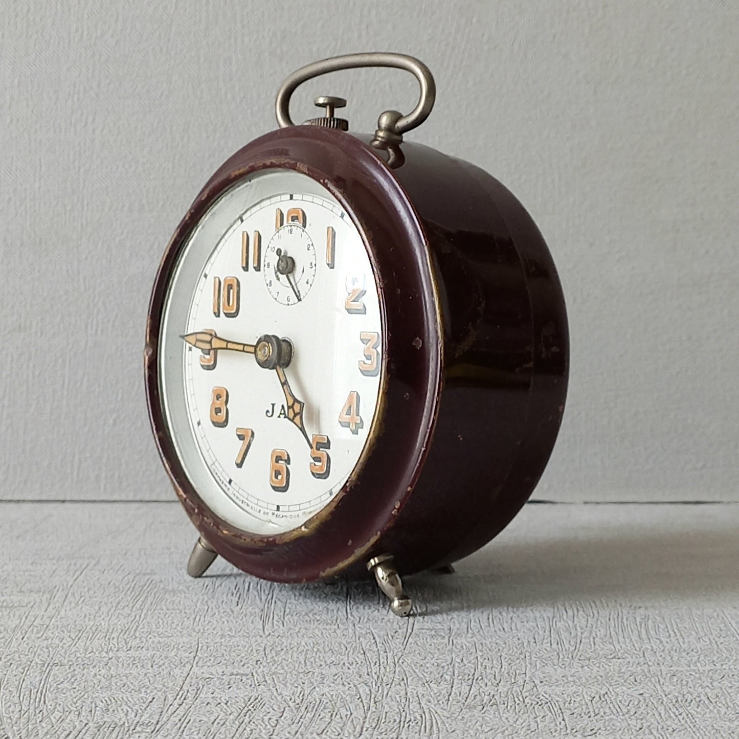 A handsome little vintage alarm clock by premier French manufacturer, Jaz.
This wonderful little clock is in semi-working condition including the alarm, although I should note that being an old time piece dating from the pre-1940 period he's temperamental and sometimes will just stop working, although all that's needed is a gentle shake from side to side and he will once more begin to tick - sometimes you might have to repeat this and have patience with him.