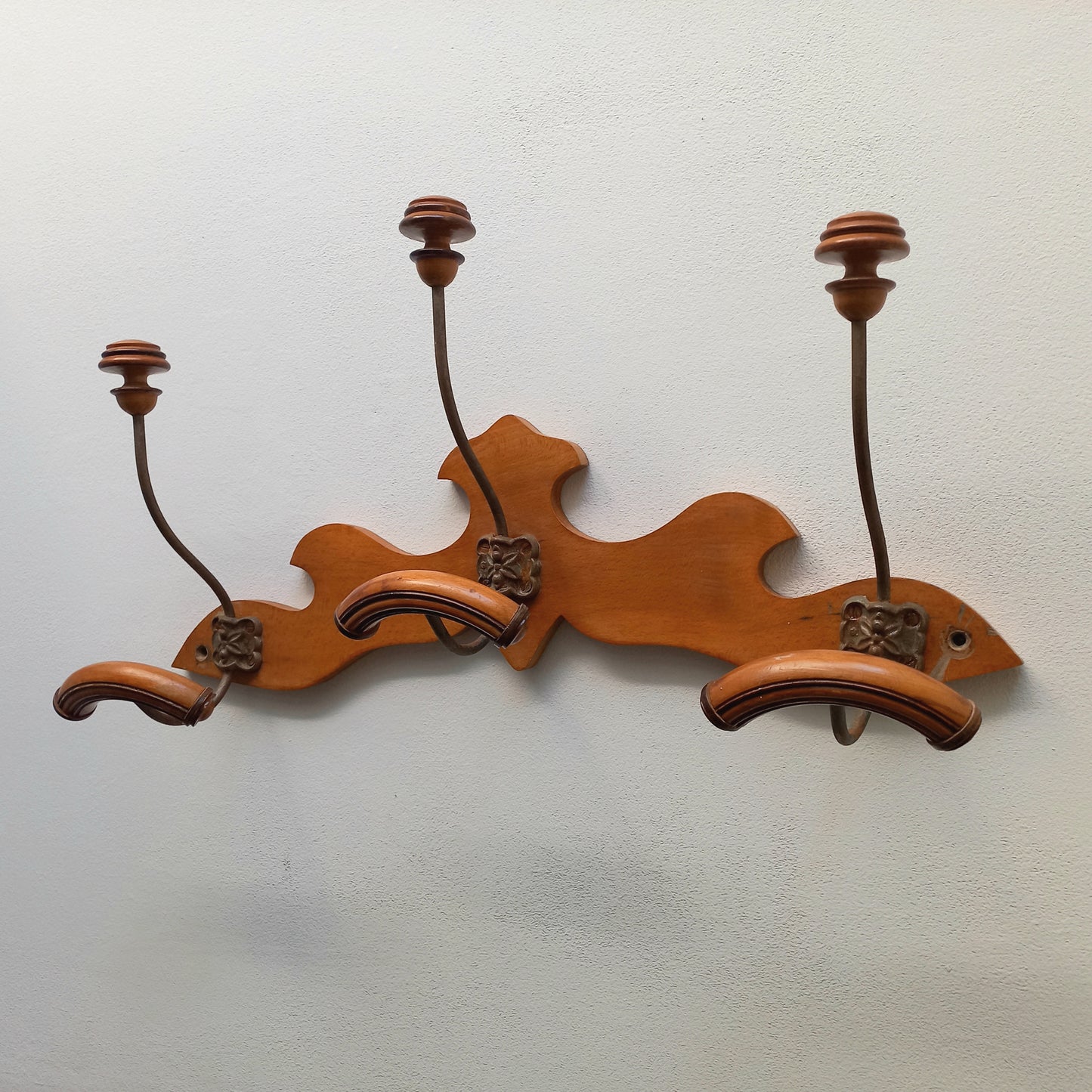 A stunning French vintage coat and hat rack with a decorative wooden wall-mounted rack holding 3 metal hooks, each hook having 2 turned wooden pegs for a hat and coat.
In summary a decorative and practical piece of vintage wall decor for any interior.