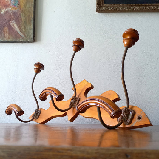 A stunning French vintage coat and hat rack with a decorative wooden wall-mounted rack holding 3 metal hooks, each hook having 2 turned wooden pegs for a hat and coat.
In summary a decorative and practical piece of vintage wall decor for any interior.