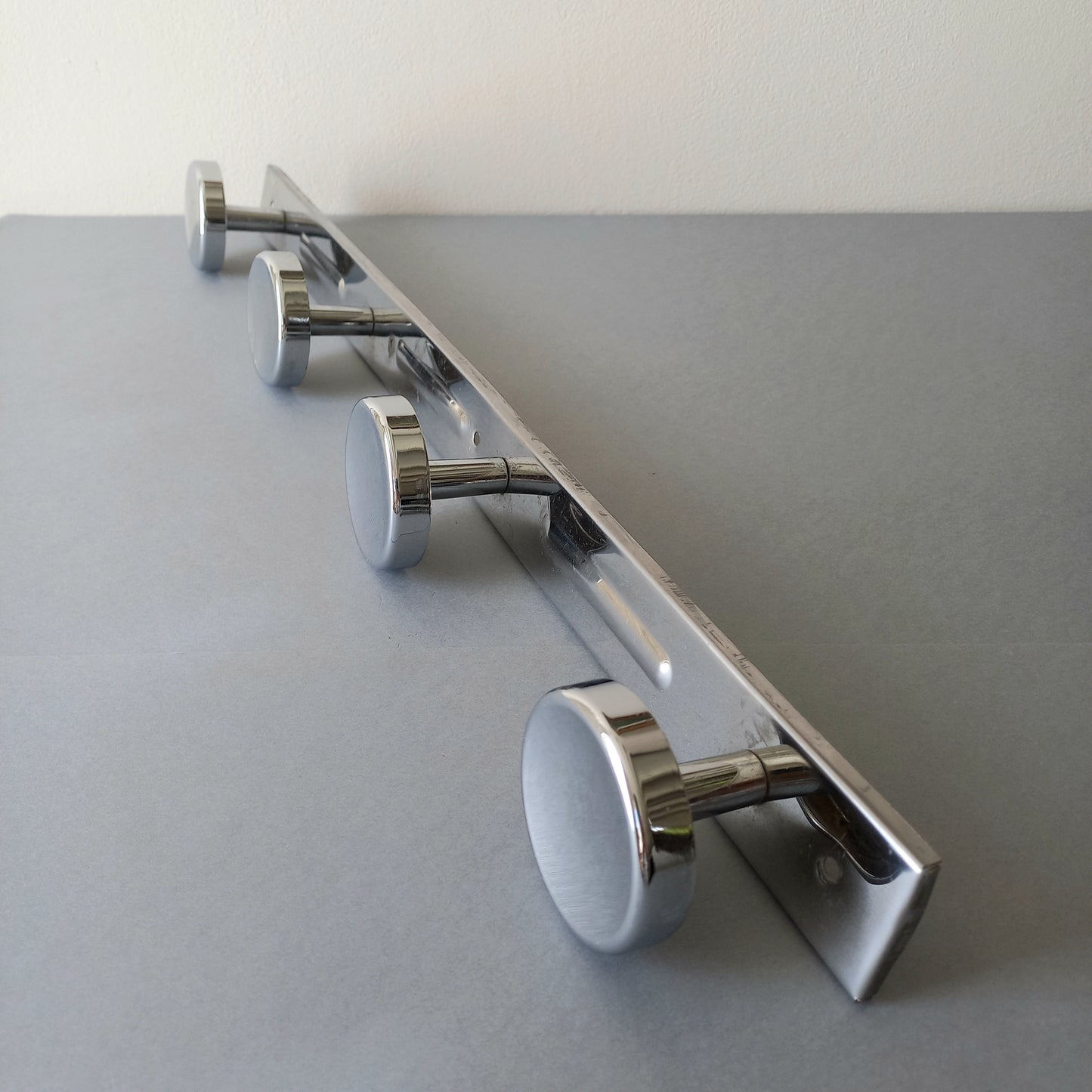 A stylish French vintage 4 peg metal coat rack with a polished finish, a great piece of practical wall decor for your home.