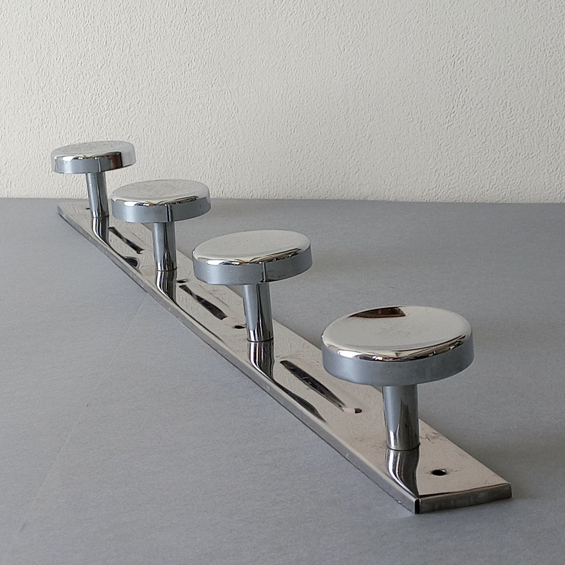 A stylish French vintage 4 peg metal coat rack with a polished finish, a great piece of practical wall decor for your home.