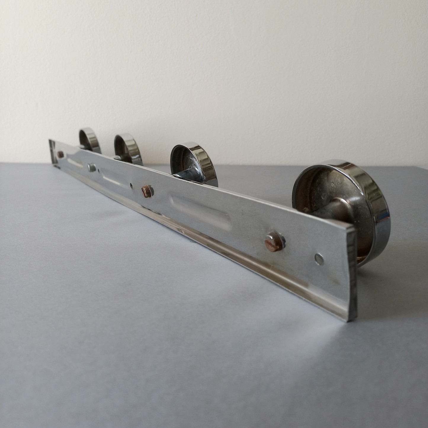 A stylish French vintage 4 peg metal coat rack with a polished finish, a great piece of practical wall decor for your home.