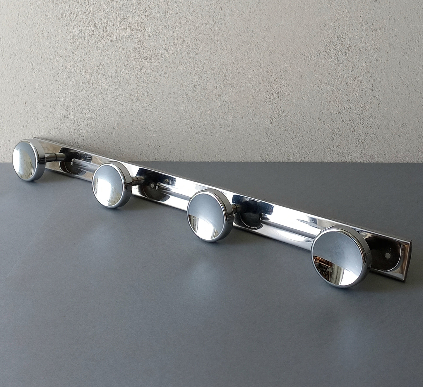 A stylish French vintage 4 peg metal coat rack with a polished finish, a great piece of practical wall decor for your home.