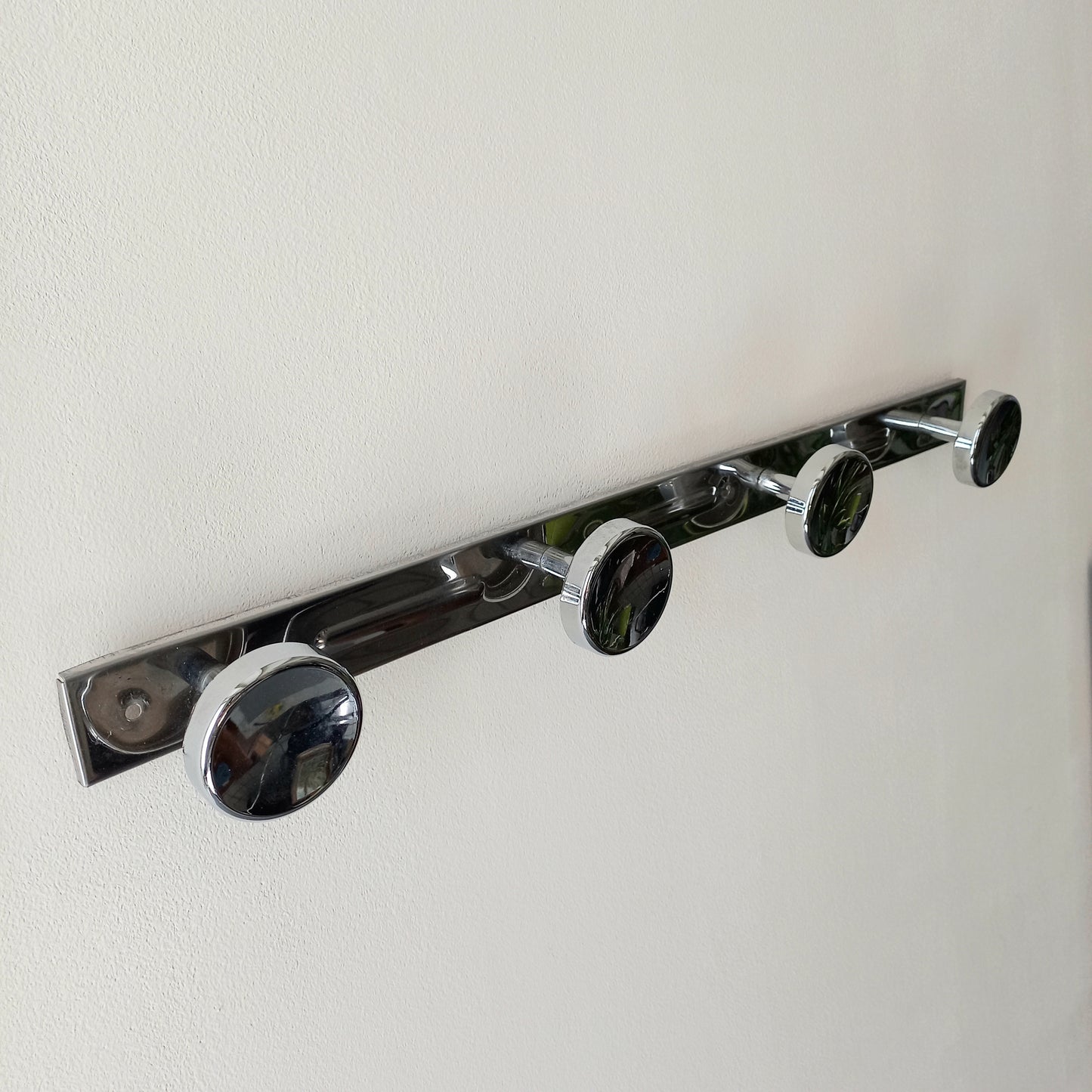 A stylish French vintage 4 peg metal coat rack with a polished finish, a great piece of practical wall decor for your home.