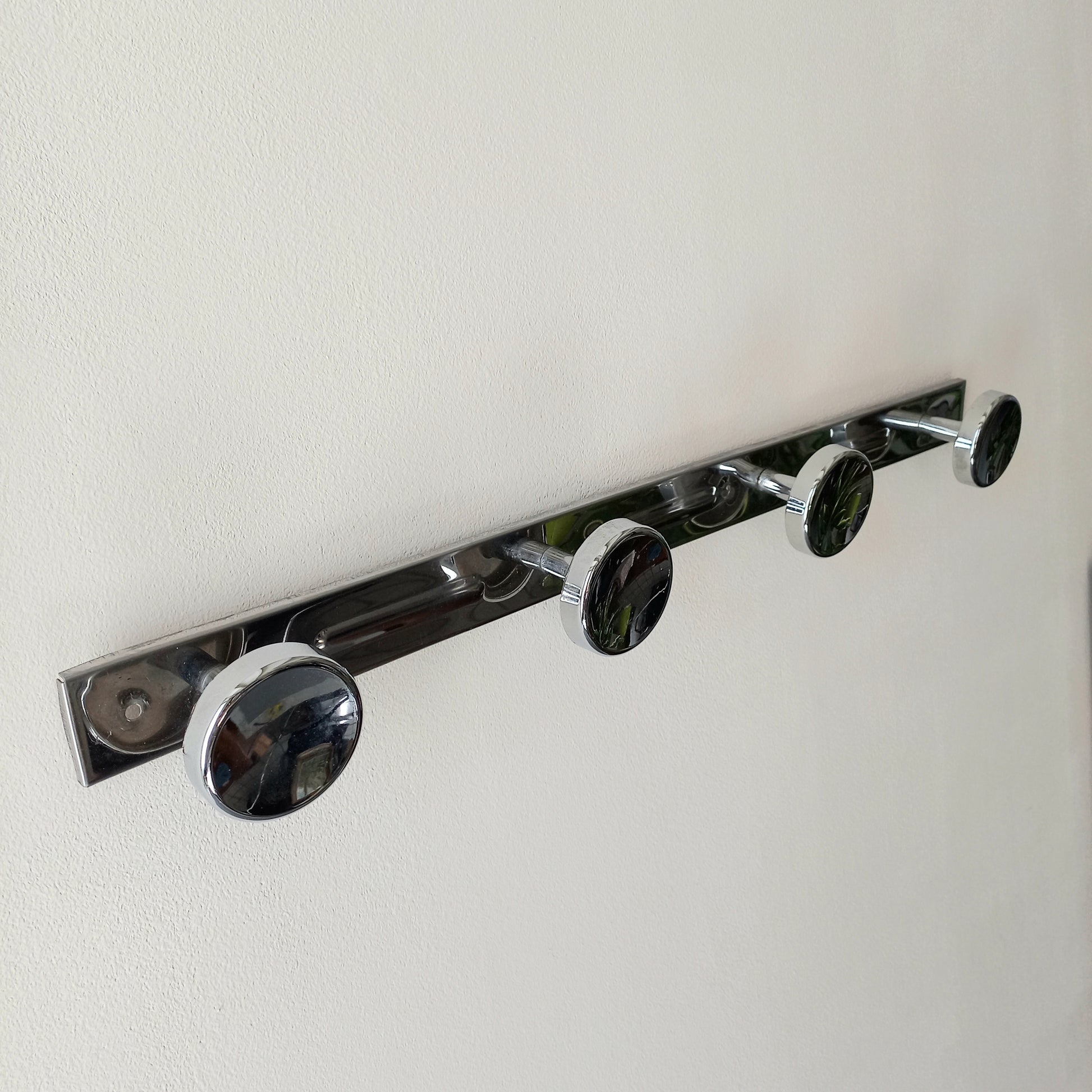 A stylish French vintage 4 peg metal coat rack with a polished finish, a great piece of practical wall decor for your home.