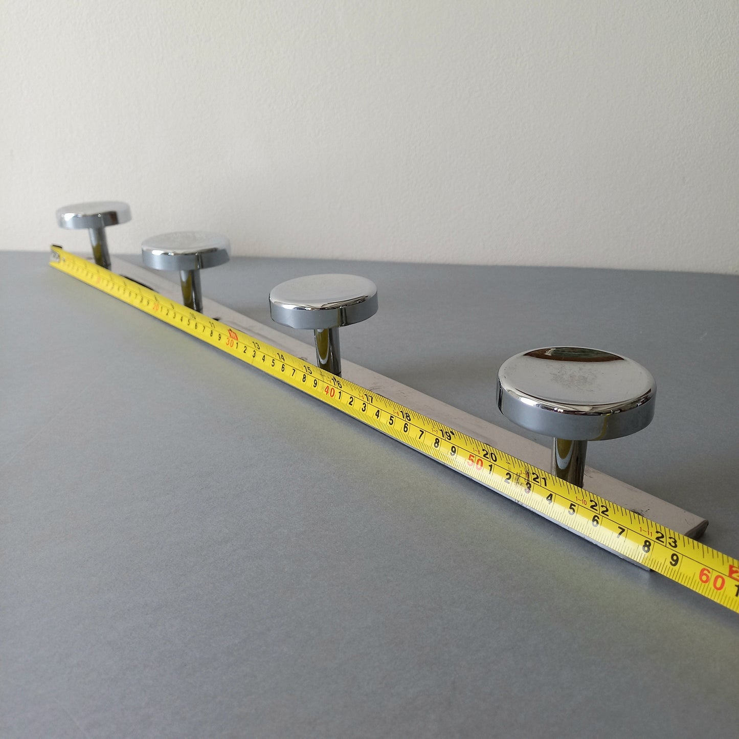 A stylish French vintage 4 peg metal coat rack with a polished finish, a great piece of practical wall decor for your home.