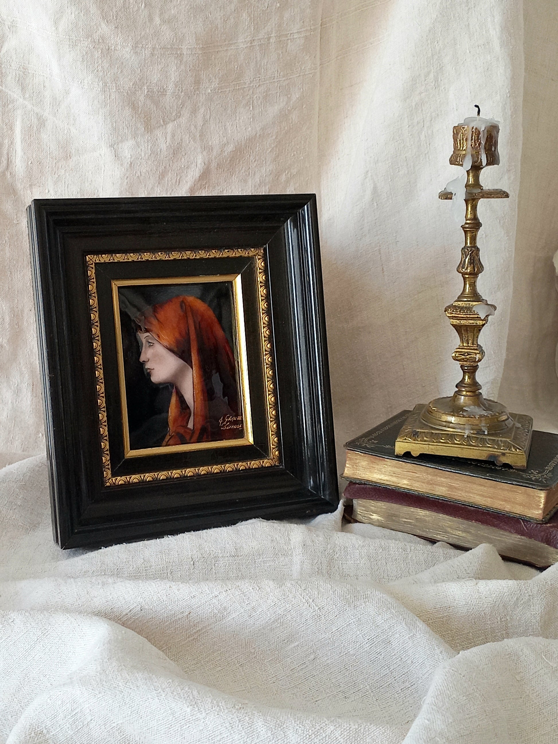 A French vintage religious enamel Saint Fabiola portrait painting by Limoges of France. The religious figure has been hand-painted in enamels on copper and signed by the artist. The art is presented in a dark brown frame with a label to the rear that tells us it's a genuine hand-made enamel artwork.
