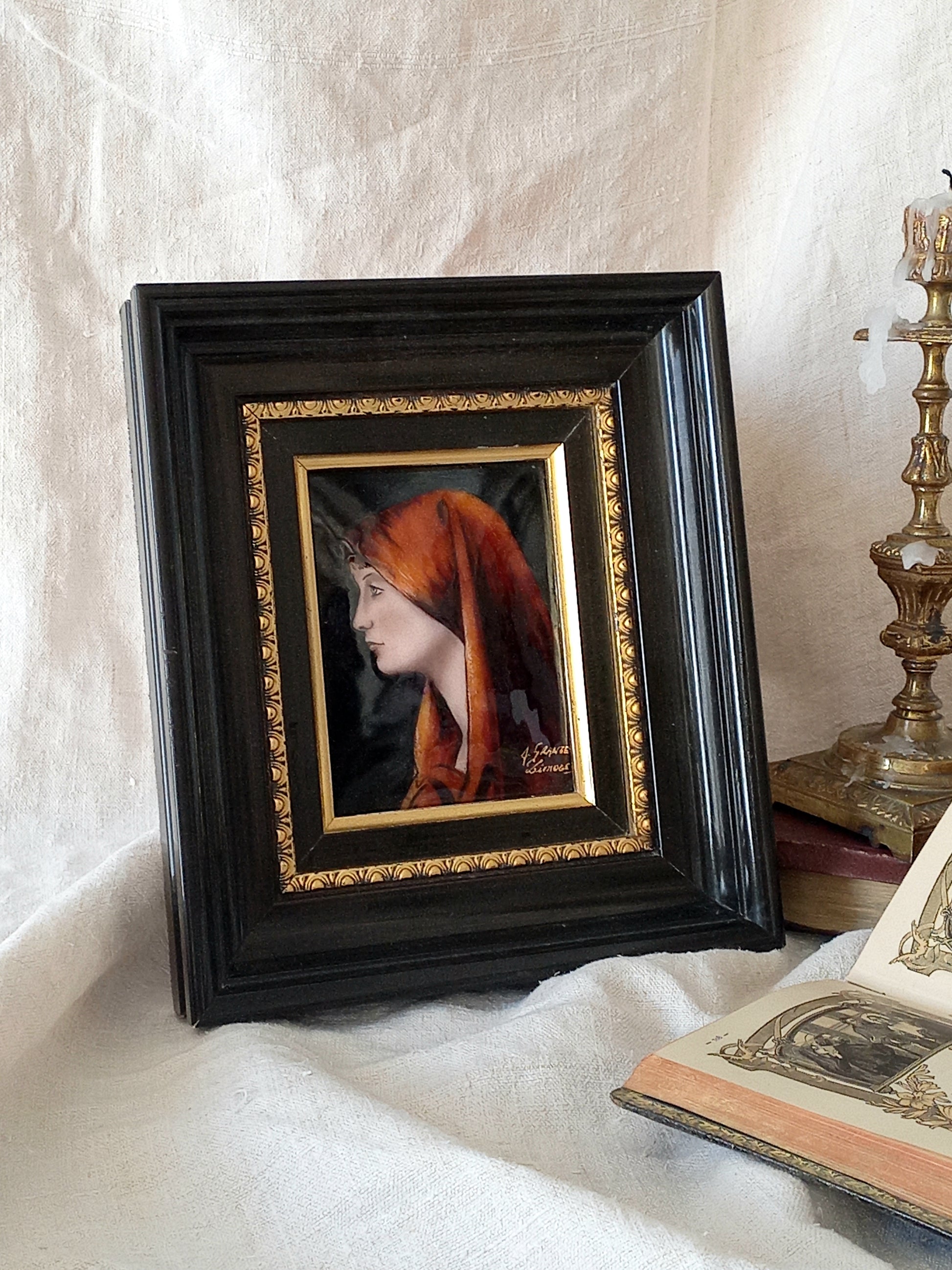 A French vintage religious enamel Saint Fabiola portrait painting by Limoges of France. The religious figure has been hand-painted in enamels on copper and signed by the artist. The art is presented in a dark brown frame with a label to the rear that tells us it's a genuine hand-made enamel artwork.