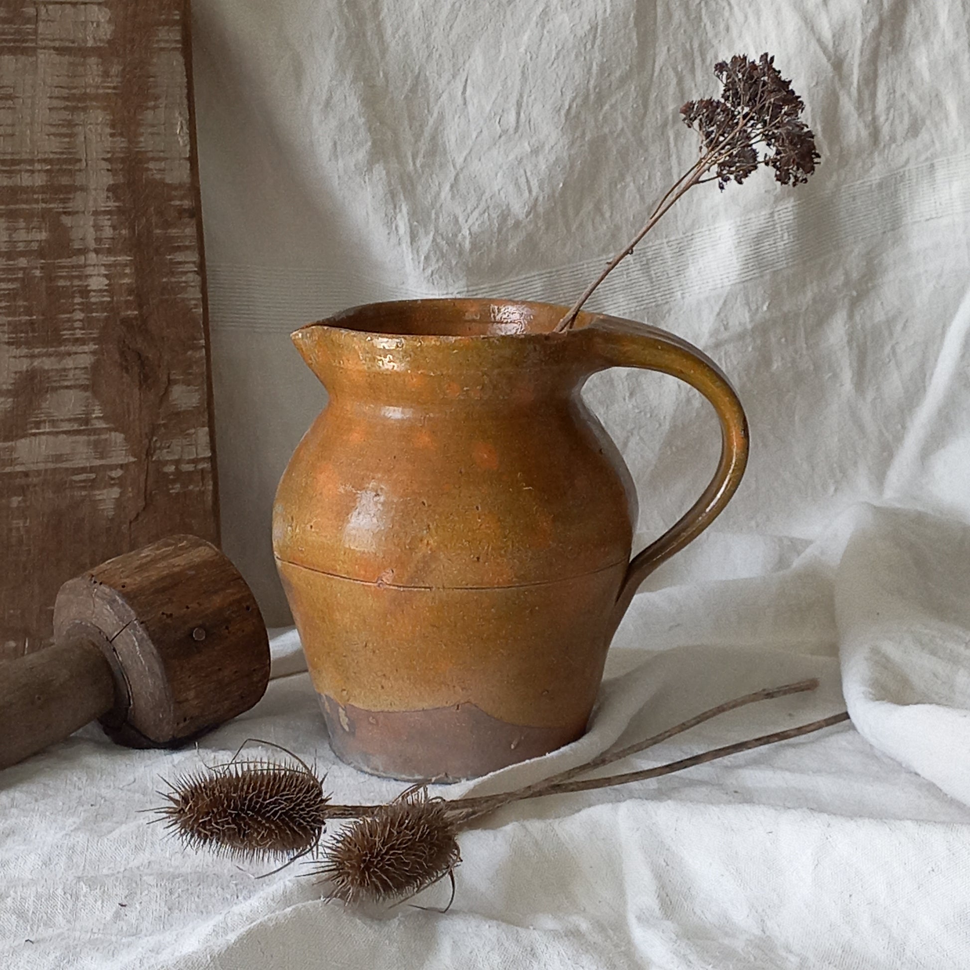 A rustic antique pottery glazed jug, a charming hand-made piece in a lovely shade of ochre with subtle traces of green. Underneath is the French maker's mark.
This piece of stoneware will look wonderful in any interior, particularly those of a rustic, country and farmhouse nature.