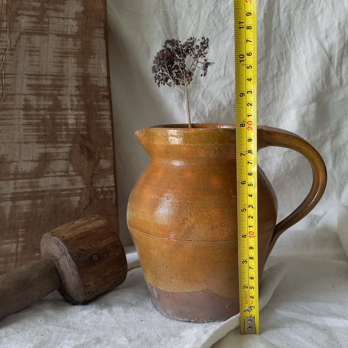 A rustic antique pottery glazed jug, a charming hand-made piece in a lovely shade of ochre with subtle traces of green. Underneath is the French maker's mark.
This piece of stoneware will look wonderful in any interior, particularly those of a rustic, country and farmhouse nature.