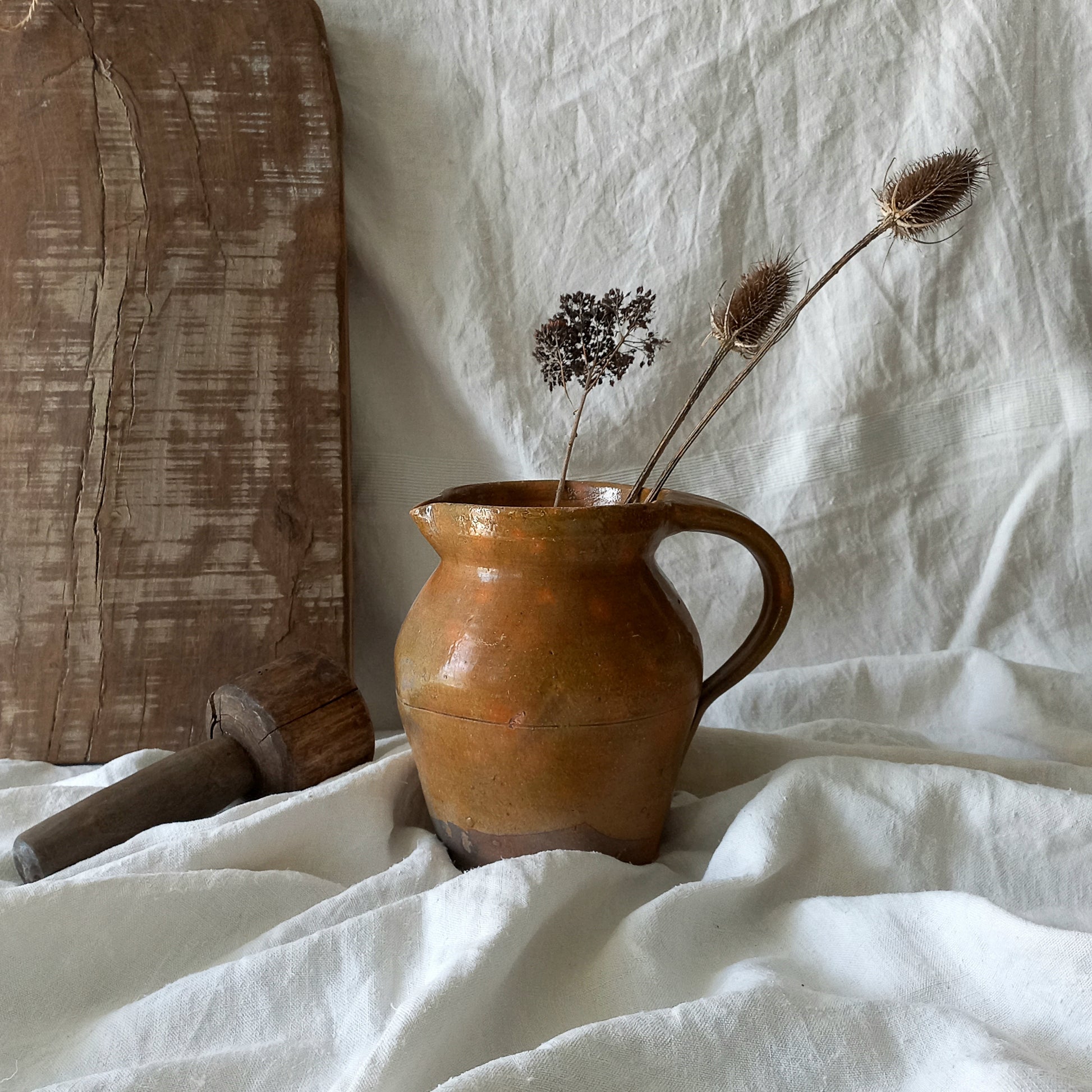 A rustic antique pottery glazed jug, a charming hand-made piece in a lovely shade of ochre with subtle traces of green. Underneath is the French maker's mark.
This piece of stoneware will look wonderful in any interior, particularly those of a rustic, country and farmhouse nature.