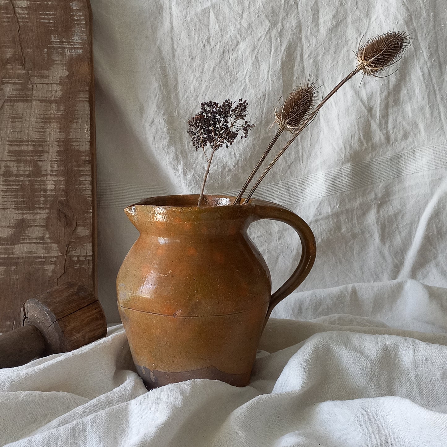 A rustic antique pottery glazed jug, a charming hand-made piece in a lovely shade of ochre with subtle traces of green. Underneath is the French maker's mark.
This piece of stoneware will look wonderful in any interior, particularly those of a rustic, country and farmhouse nature.