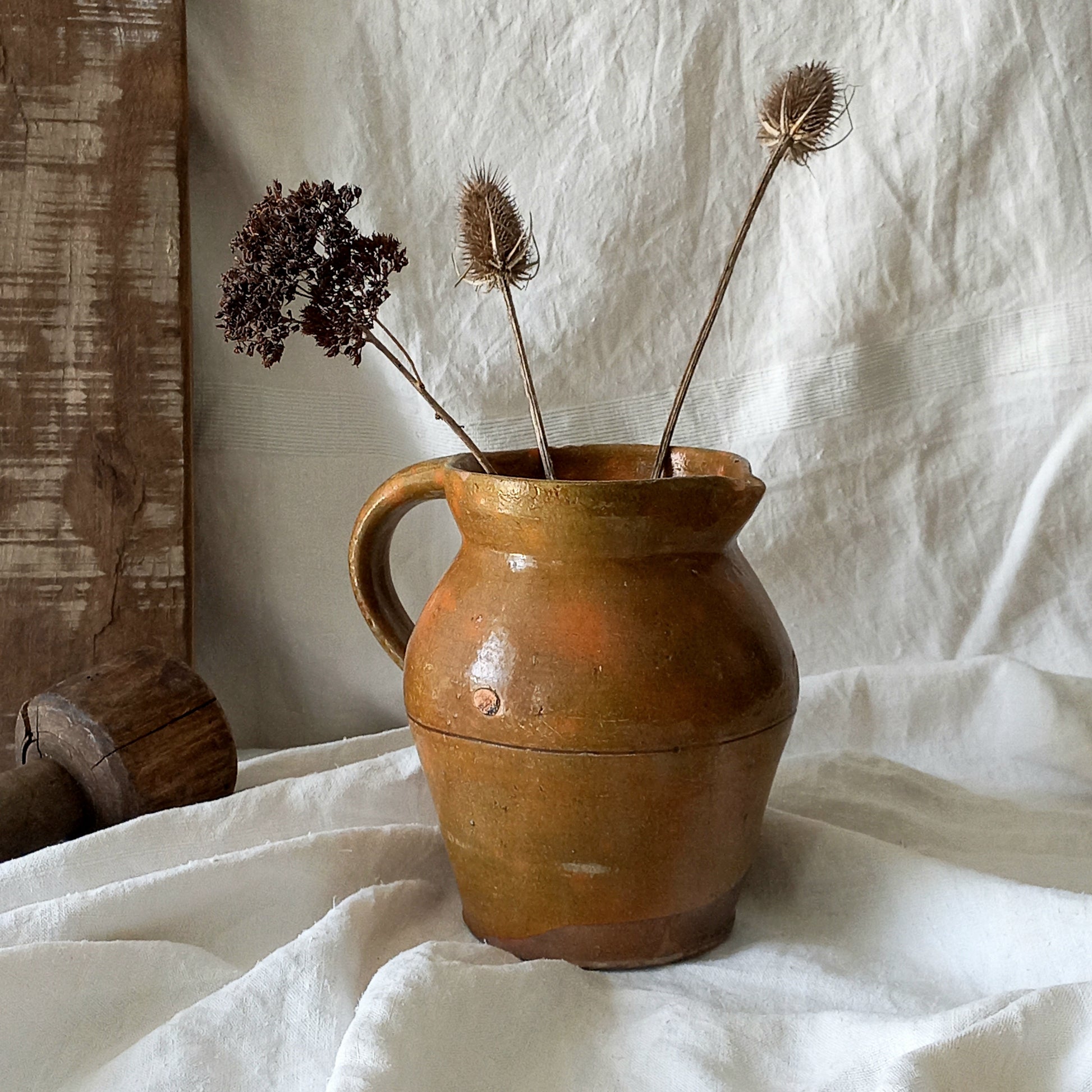 A rustic antique pottery glazed jug, a charming hand-made piece in a lovely shade of ochre with subtle traces of green. Underneath is the French maker's mark.
This piece of stoneware will look wonderful in any interior, particularly those of a rustic, country and farmhouse nature.