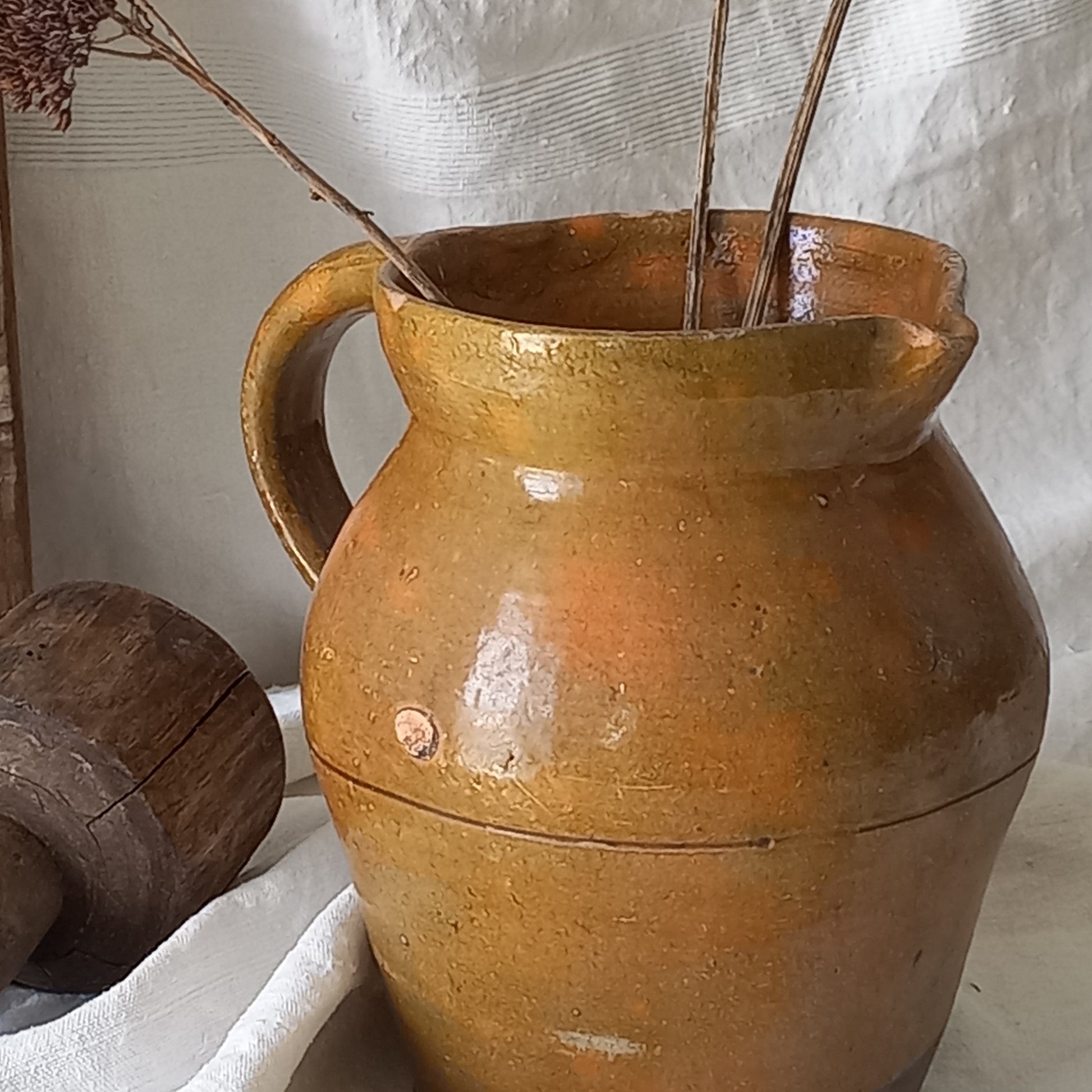 A rustic antique pottery glazed jug, a charming hand-made piece in a lovely shade of ochre with subtle traces of green. Underneath is the French maker's mark.
This piece of stoneware will look wonderful in any interior, particularly those of a rustic, country and farmhouse nature.