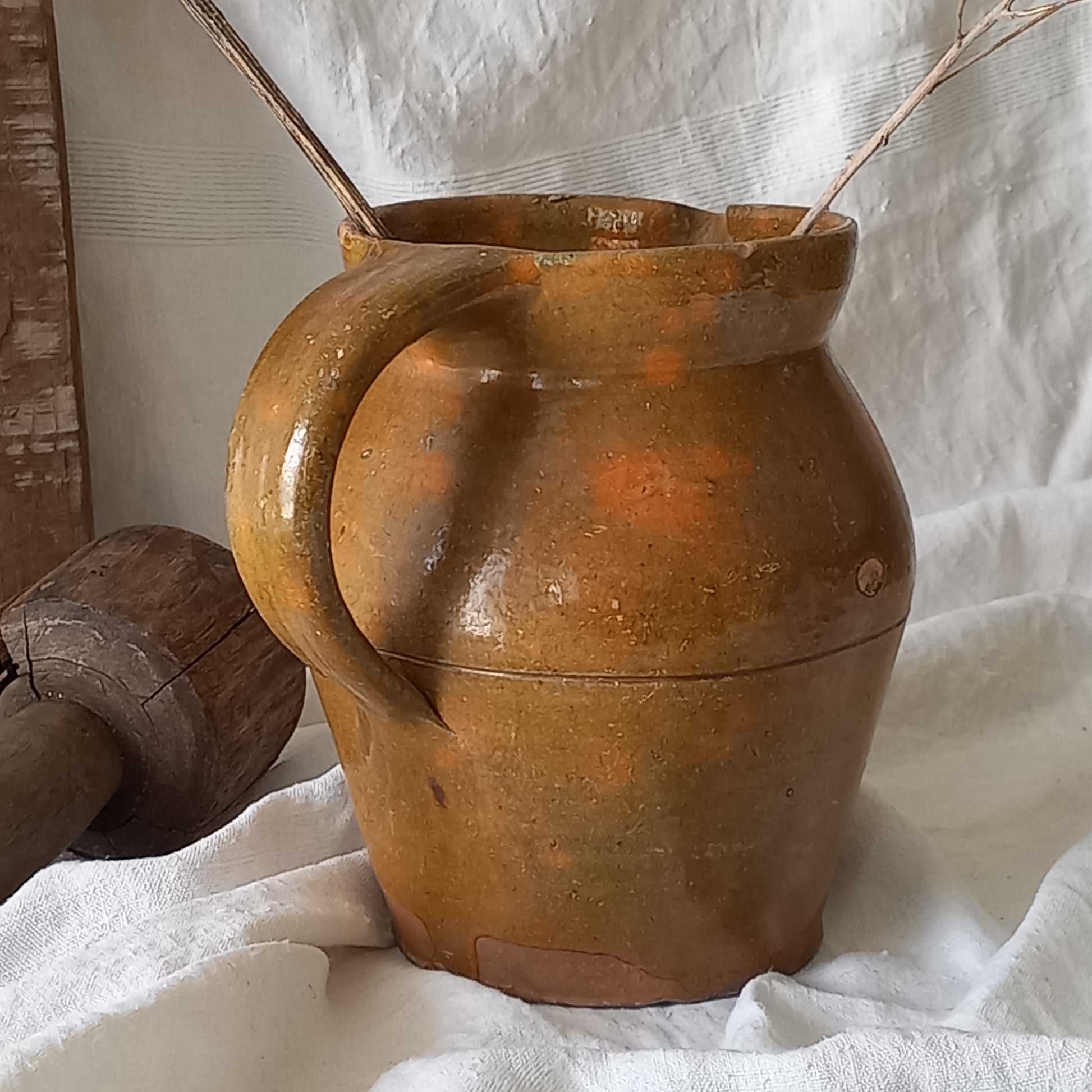 A rustic antique pottery glazed jug, a charming hand-made piece in a lovely shade of ochre with subtle traces of green. Underneath is the French maker's mark.
This piece of stoneware will look wonderful in any interior, particularly those of a rustic, country and farmhouse nature.