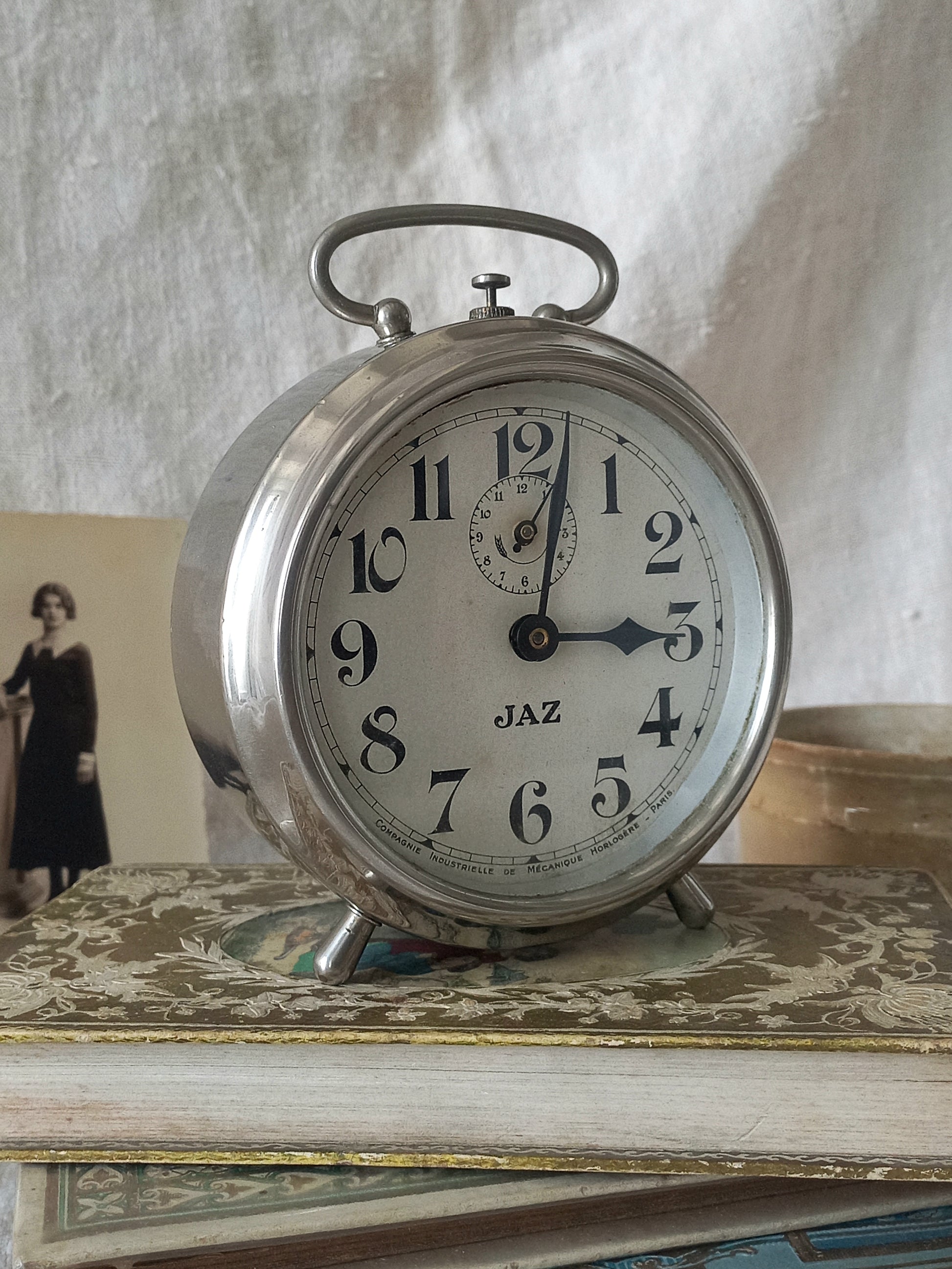 Original vintage Jaz alarm clock on books with a rustic background