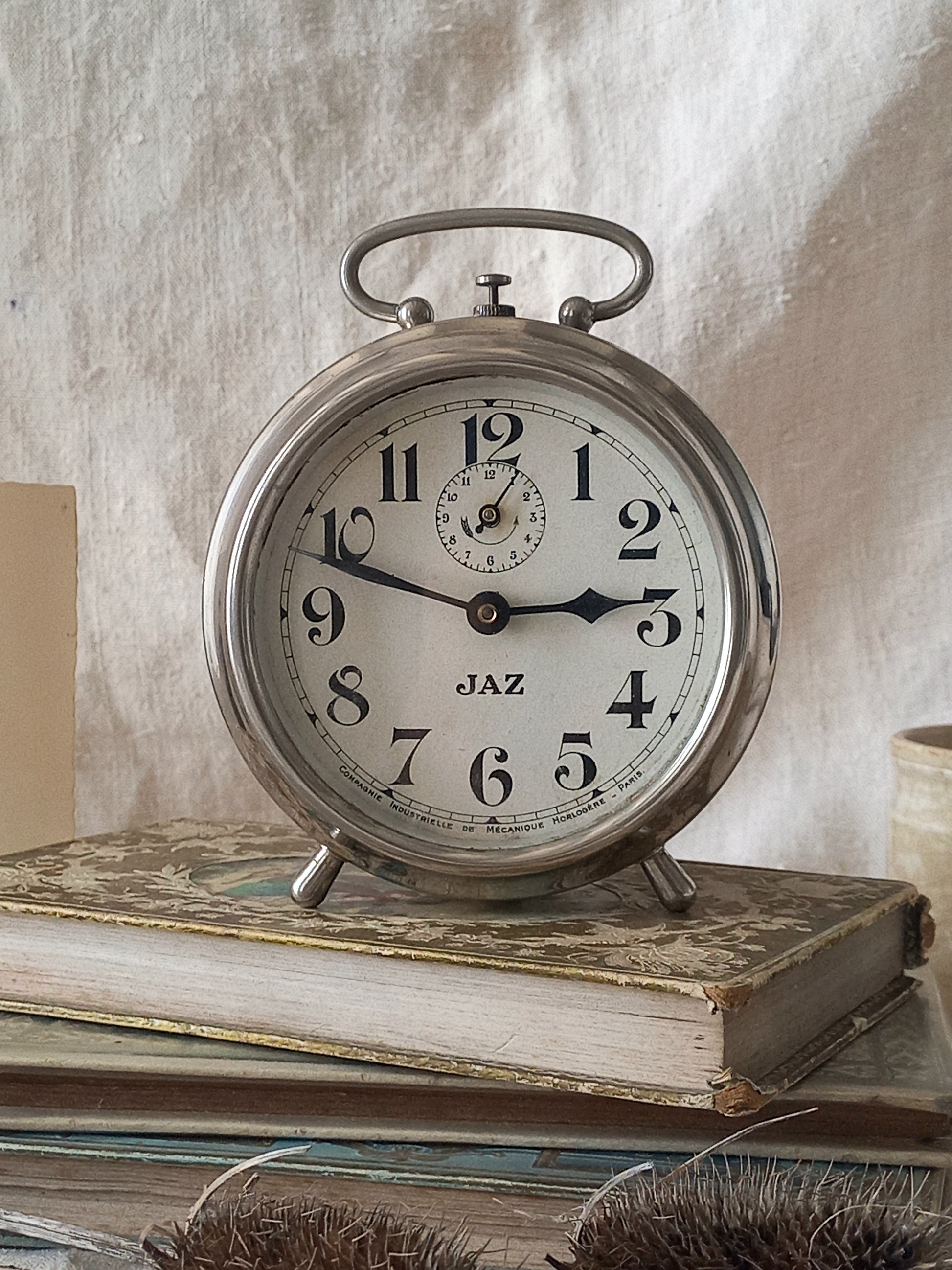 Original vintage Jaz alarm clock on books with a rustic background