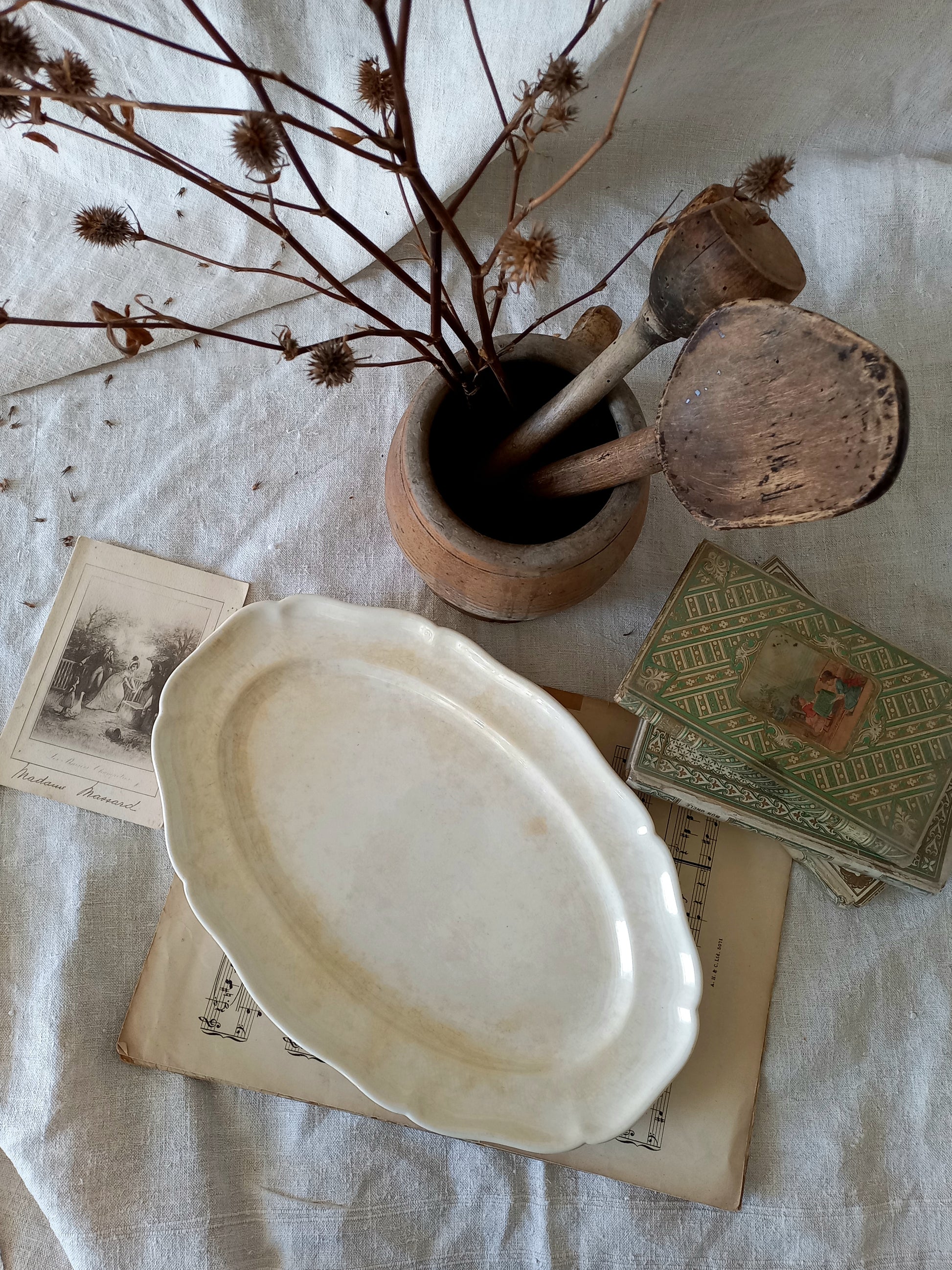 A beautiful vintage oval ironstone serving plate with decorative edges in a time-worn creamy white with super tea-staining that gives it that shabby chic finish many of us desire.