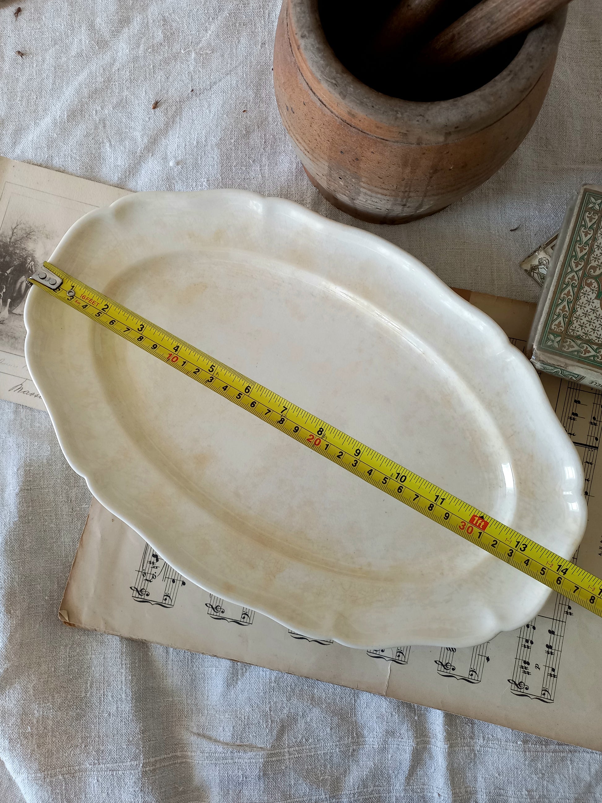 A beautiful vintage oval ironstone serving plate with decorative edges in a time-worn creamy white with super tea-staining that gives it that shabby chic finish many of us desire.