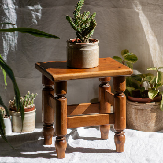 A handsome vintage French wooden stool in a lovely shade of honey-coloured brown. This old stool is very solid and would make a great plant stand (we currently use one on our desk as a plant stand and it looks great!) and many other decorative possibilities.