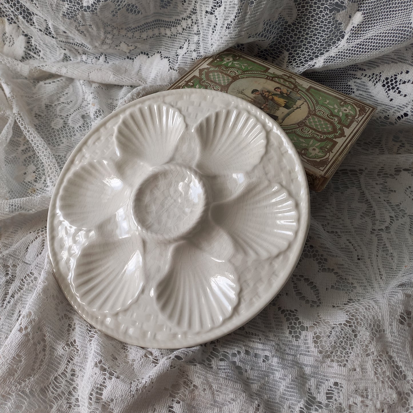 Decorative vintage oyster plate in creamy white colour, French seafood plate