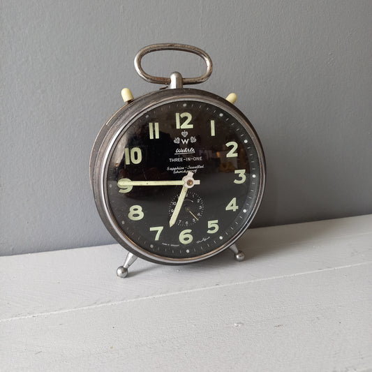 A large vintage mechanical alarm clock by German manufacturer Wehrle, a quality and heavy time-piece. A rare three-in-one clock in working condition including the chiming alarm - it can also sound on the hour and half hour. Gives a pleasing ticking sound and as you can see in the 4th photo, illuminates for a short time after lights out. The overall condition of the clock is used with obvious signs of age-related wear and rusty patina. Circa. 1960s/70s.