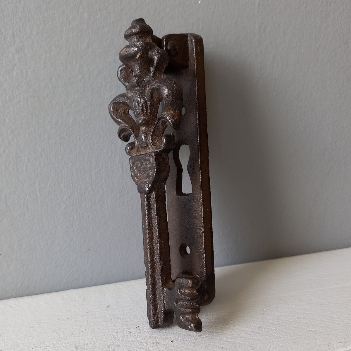 Decorative metal bracket on a light gray background