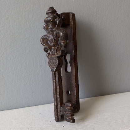 Decorative metal bracket on a light gray background