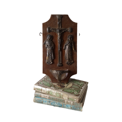 Wall-mounted vintage/antique religious wall decor with metal crucifix and religious figures, and a glass Holy Water font mounted to a wooden base. A great piece of original religious decor from France.
