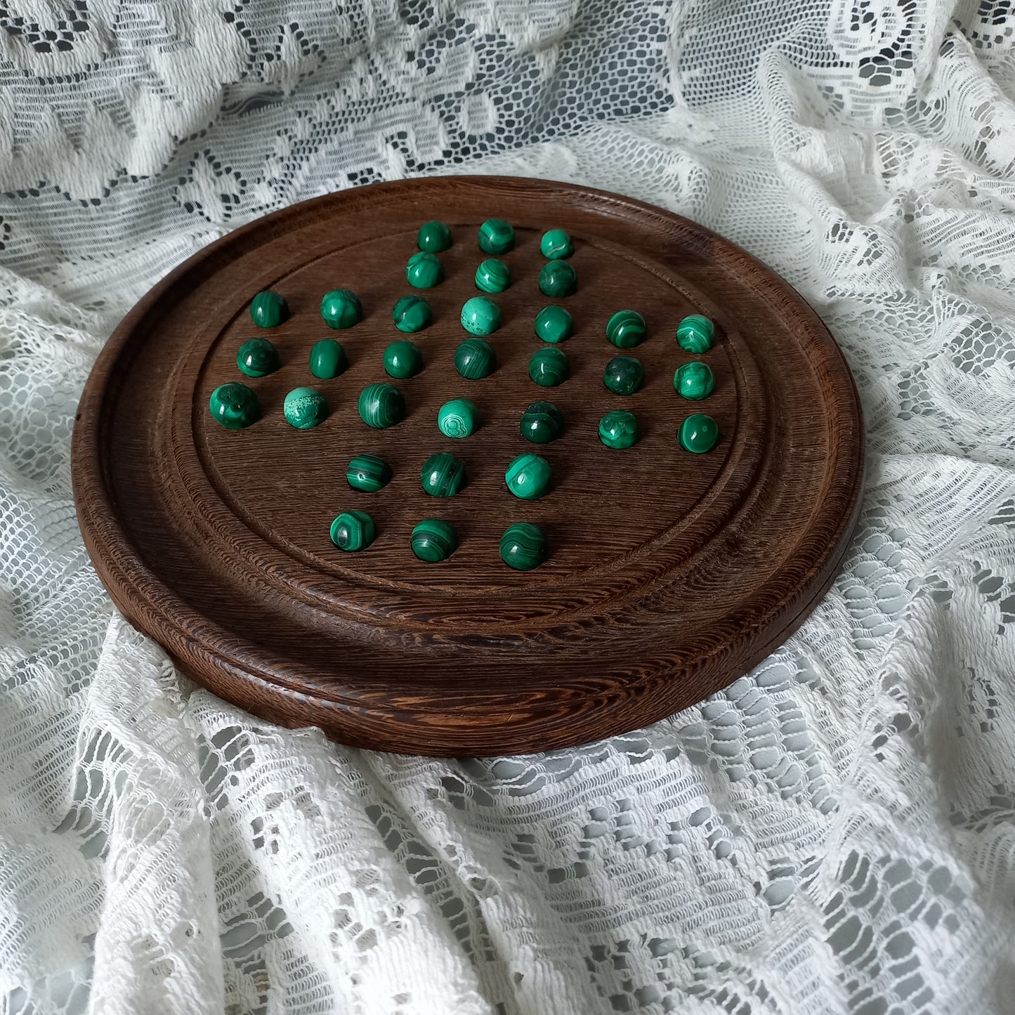 Handmade wooden solitaire board with semi-precious malachite marbles, decorative vintage board game