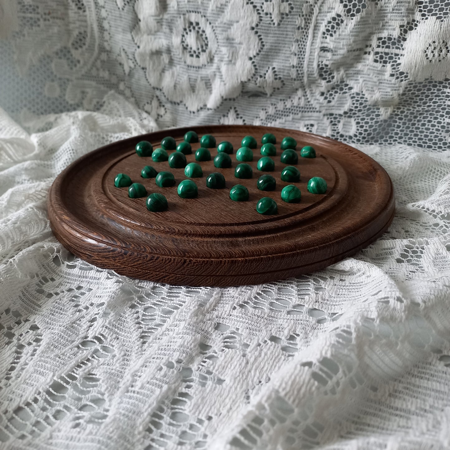 Handmade wooden solitaire board with semi-precious malachite marbles, decorative vintage board game