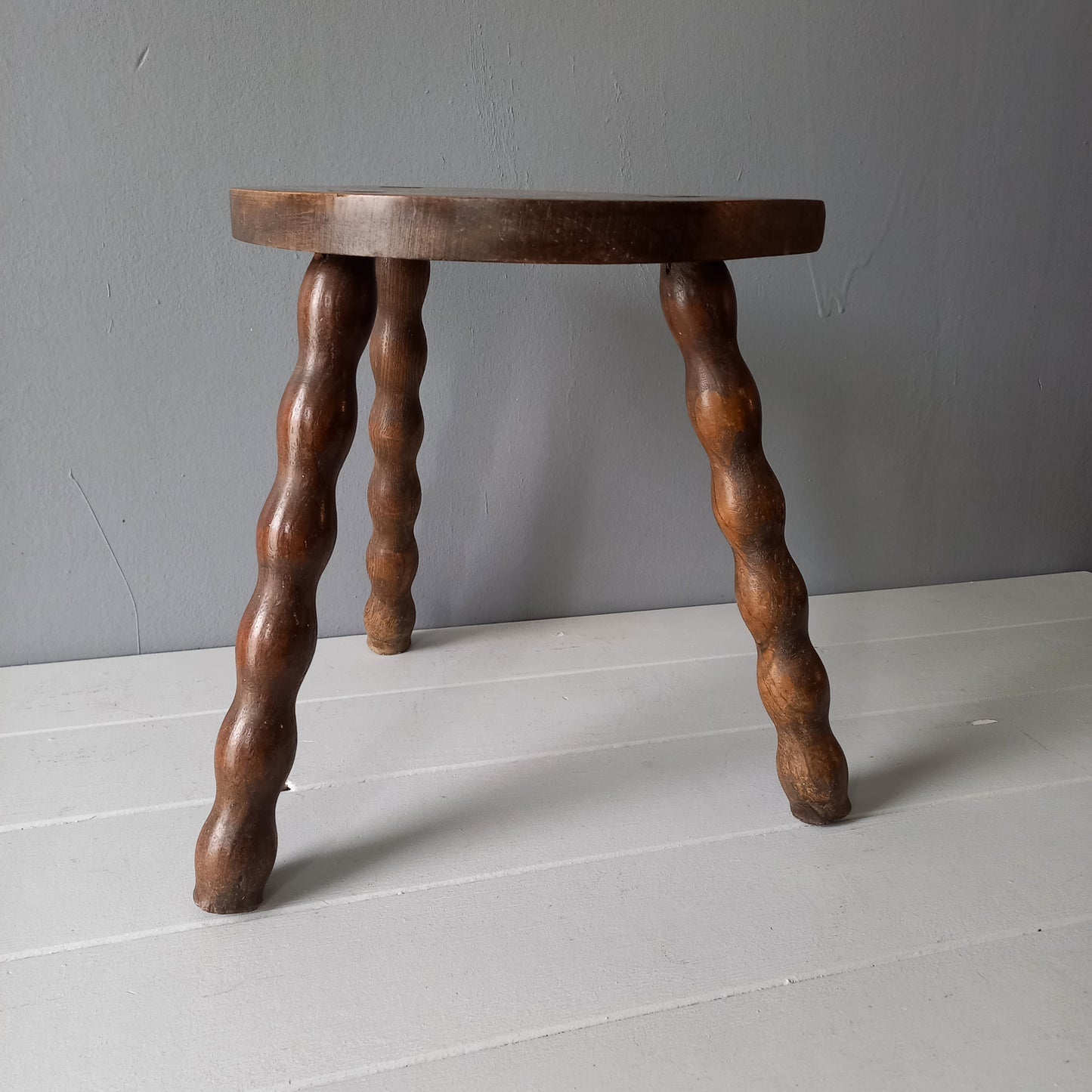 Vintage wooden stool with three turned wooden legs, rustic farmhouse decor, plant stand