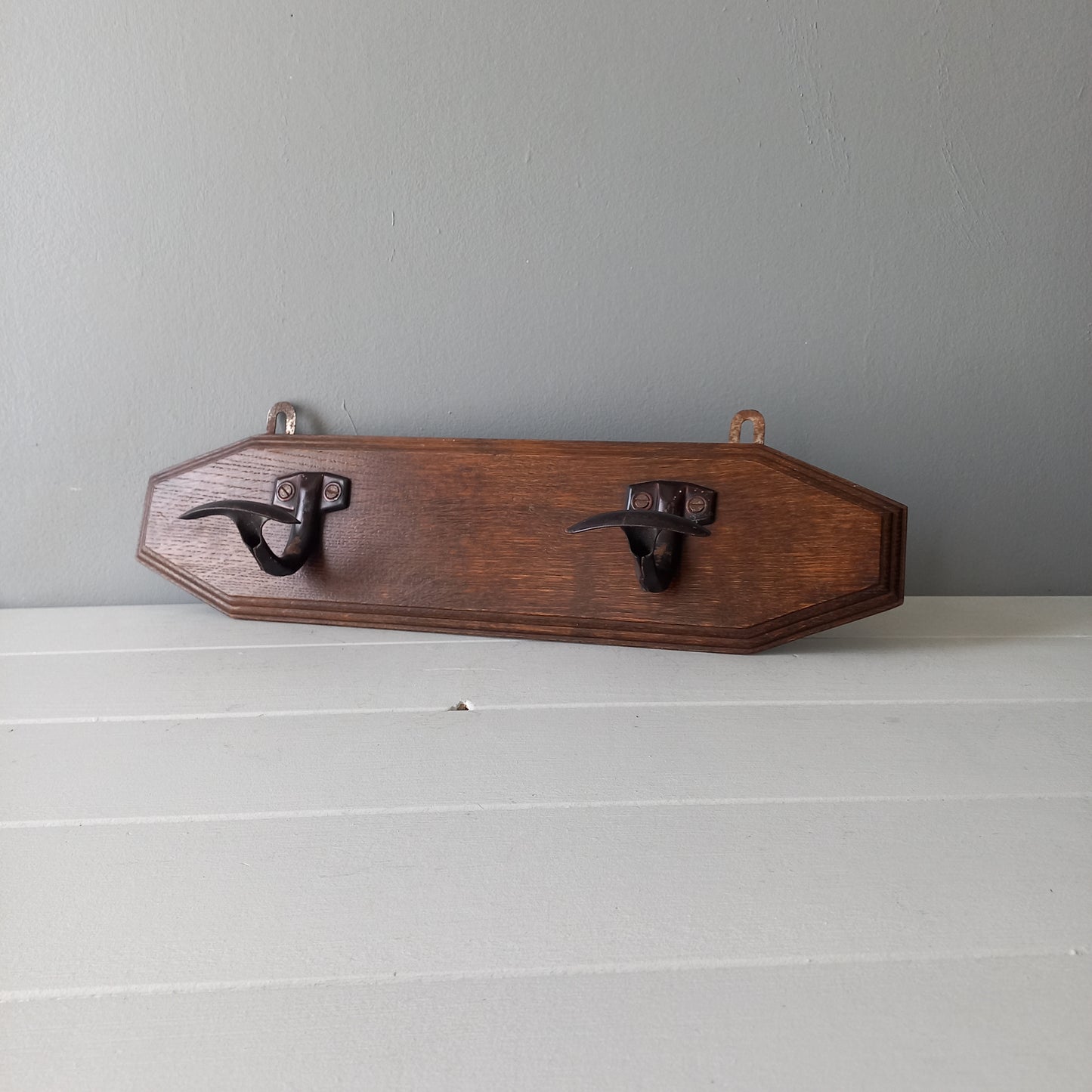 Vintage wooden coat rack with two metal coat hooks