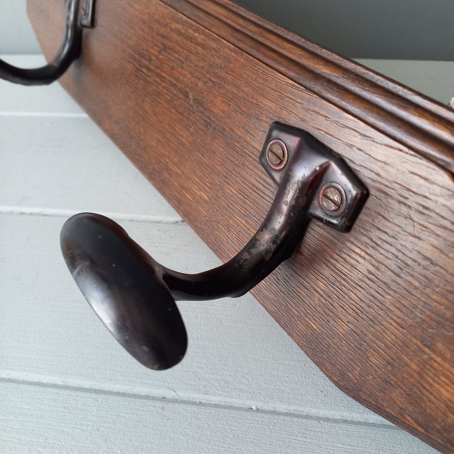 Vintage wooden coat rack with two metal coat hooks