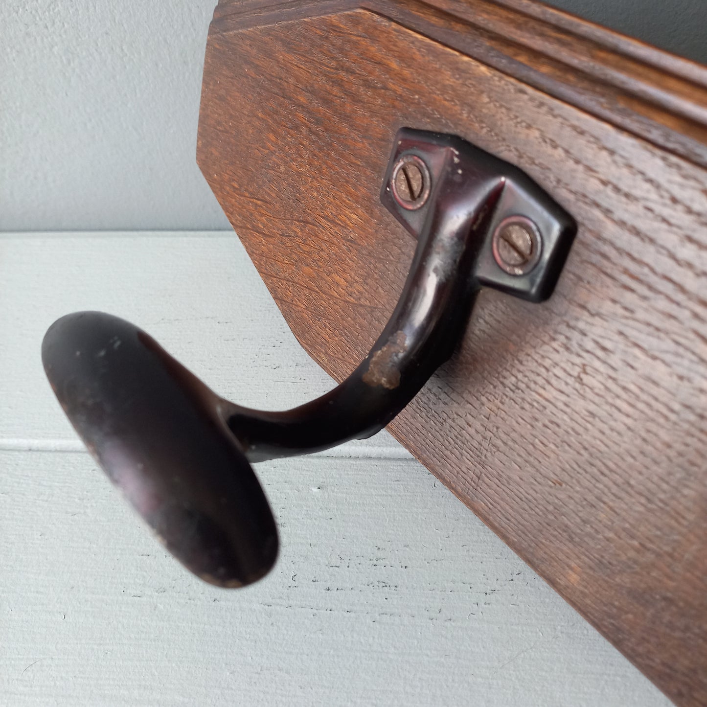 Vintage wooden coat rack with two metal coat hooks