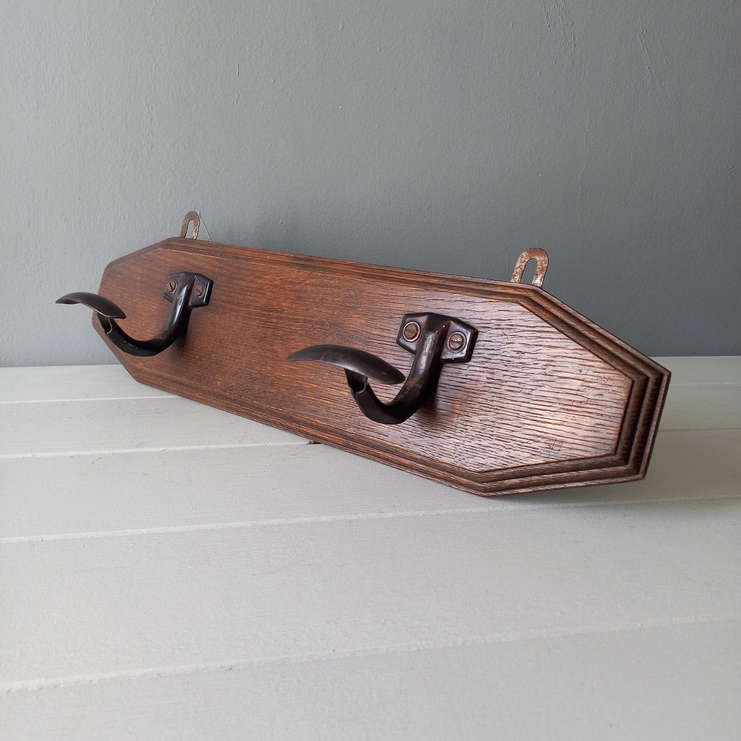 Vintage wooden coat rack with two metal coat hooks