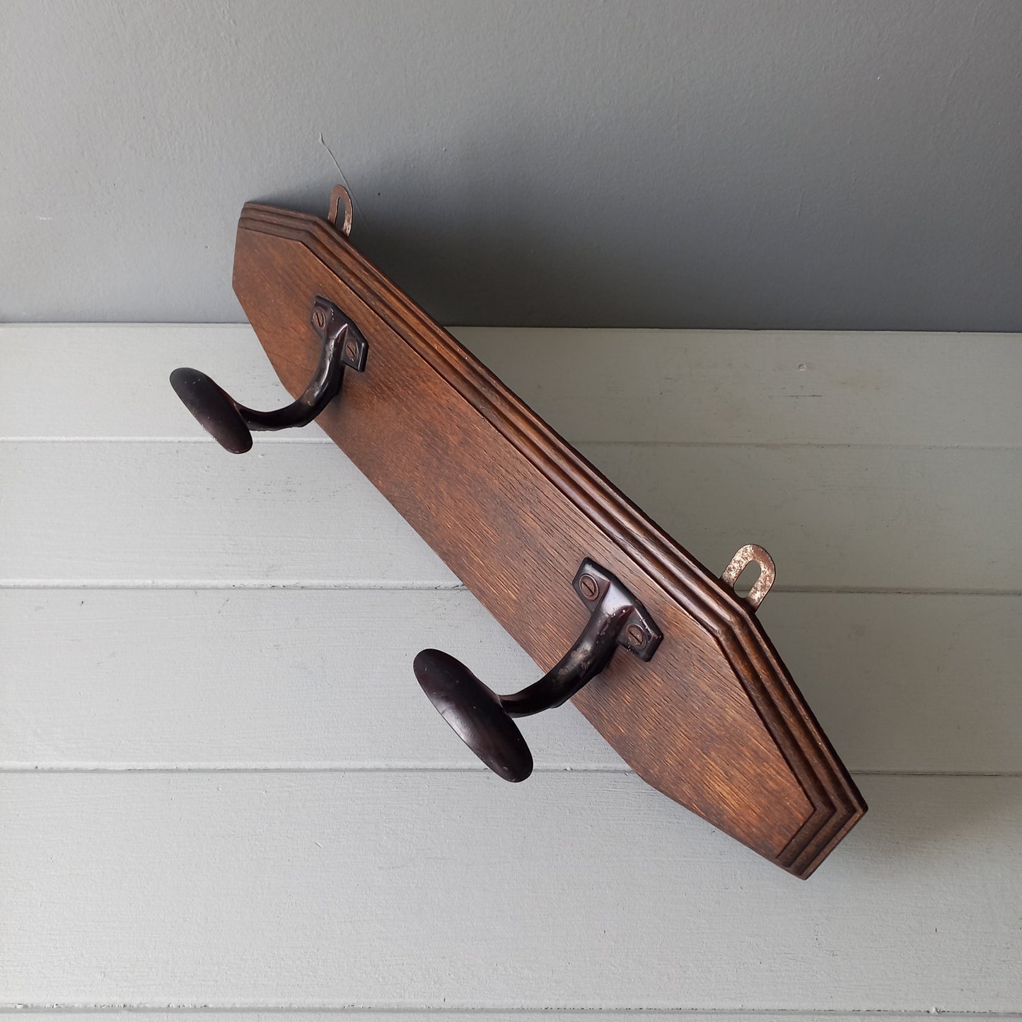 Vintage wooden coat rack with two metal coat hooks