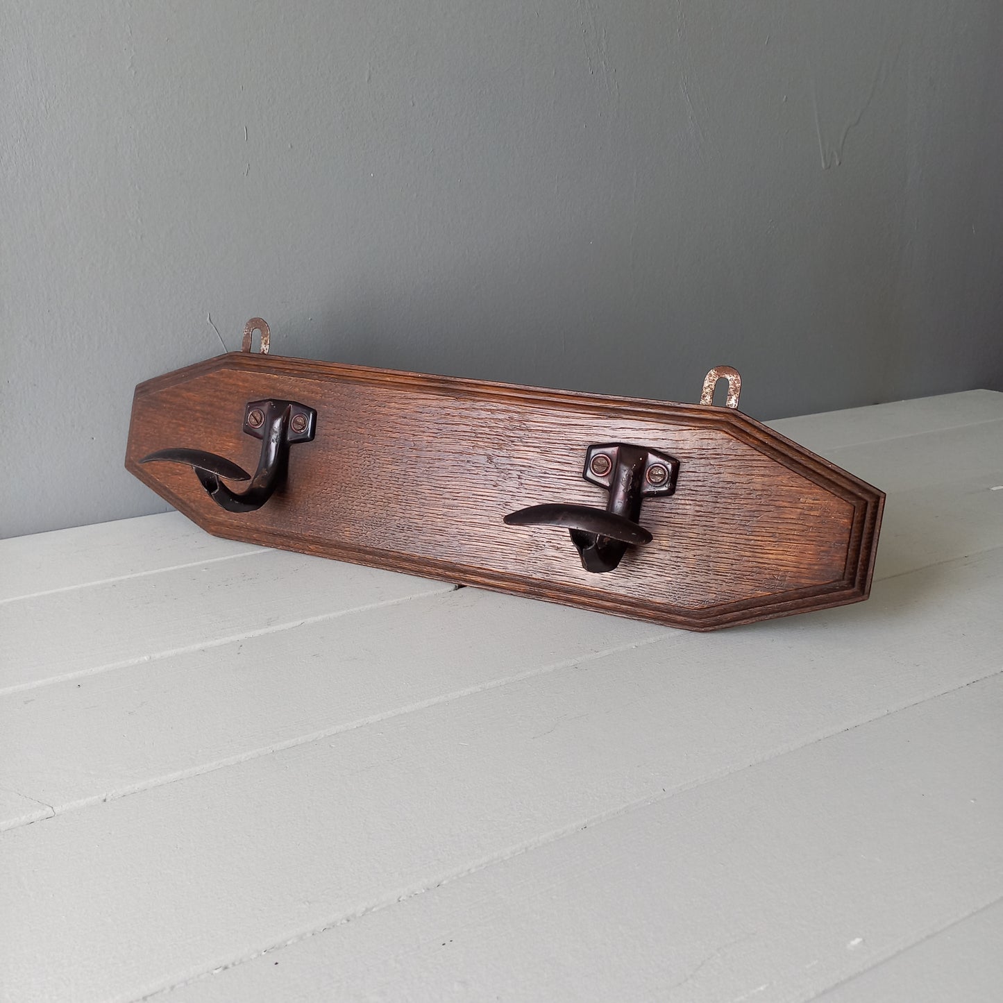 Vintage wooden coat rack with two metal coat hooks