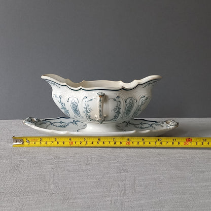 Large vintage ironstone sauce boat with a teal (blue/green) floral pattern.

This is a grand-looking and heavy piece, possibly manufactured by Villeroy Boch.

It's been well used and has the expected age-related wear - these days it's more suitable for home decor such as a herb planter and many other interesting uses.