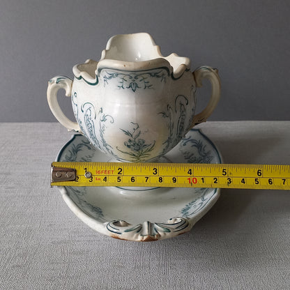 Large vintage ironstone sauce boat with a teal (blue/green) floral pattern.

This is a grand-looking and heavy piece, possibly manufactured by Villeroy Boch.

It's been well used and has the expected age-related wear - these days it's more suitable for home decor such as a herb planter and many other interesting uses.